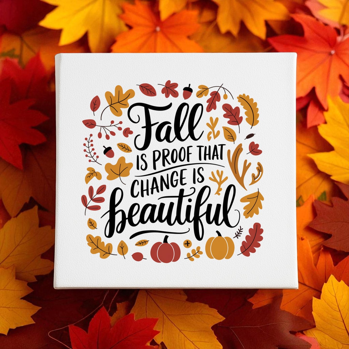 The Fall Is Proof Canvas Sign by Mirabilia Boutique is an 8x8 autumn decor piece featuring the inspiring message "Fall is proof that change is beautiful," accented with pumpkins and colorful leaves—perfect for seasonal home decor.