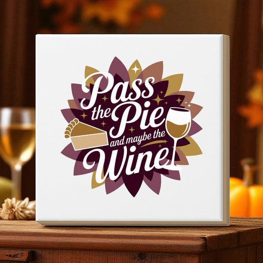The Pass the Pie and Maybe the Wine Canvas Sign by Mirabilia Boutique features a pie slice, wine glass, and its witty saying on a layered autumn flower background—funny Thanksgiving decor for your home.