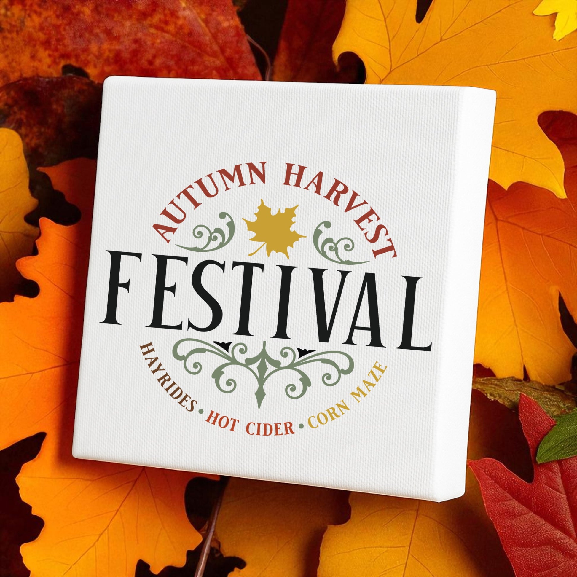 The Mirabilia Boutique Autumn Harvest Festival Canvas Sign (8x8) features rustic "Hayrides," "Hot Cider," and "Corn Maze" accents with leafy autumn decor—perfect for adding farmhouse charm to your Thanksgiving home.