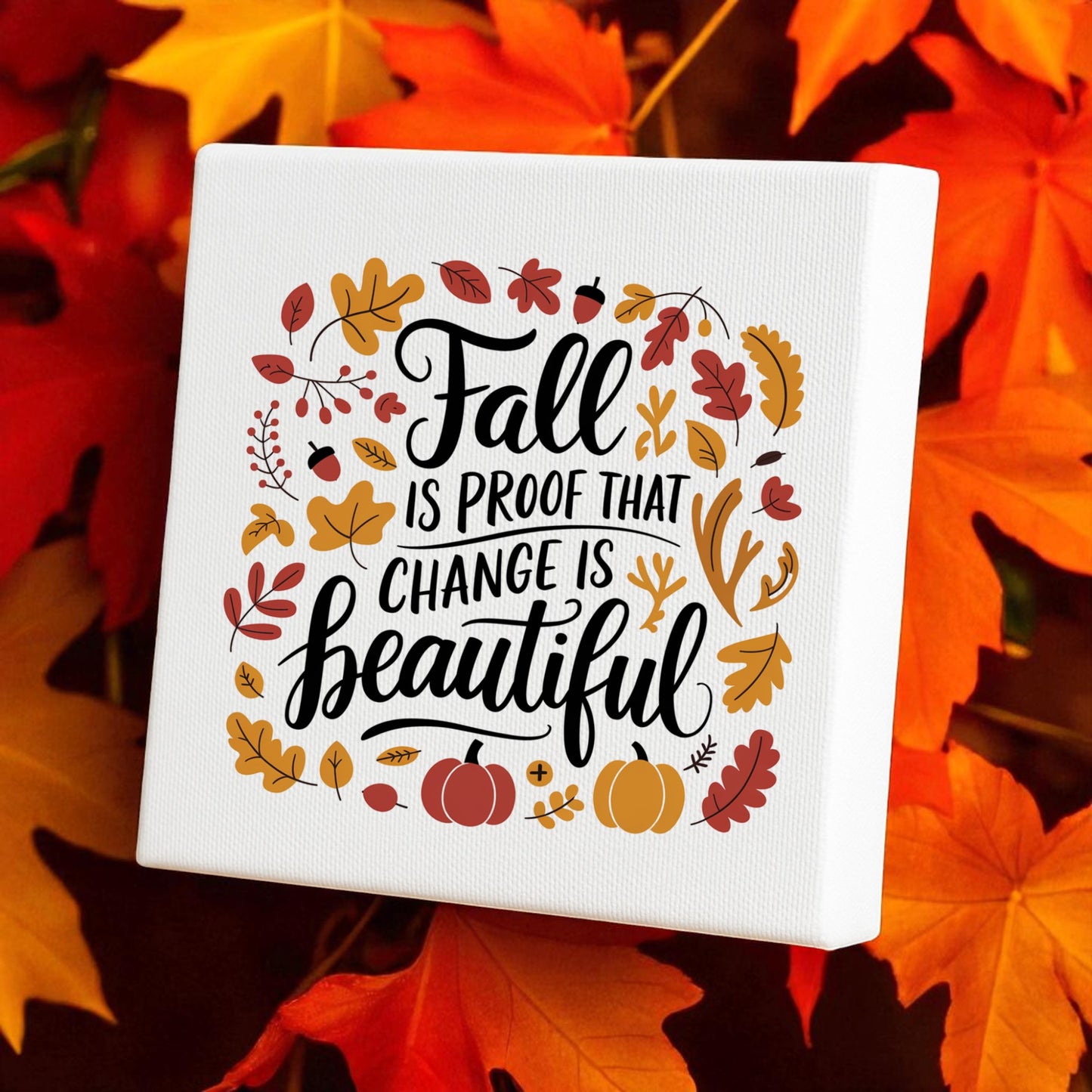 The Mirabilia Boutique Fall Is Proof Canvas Sign, an inspirational 8x8 autumn decor piece, features the quote "Fall is proof that change is beautiful" with colorful leaves and pumpkins—perfect for cozy seasonal accents.