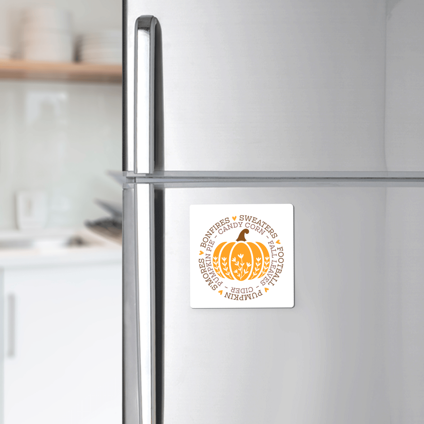 The Fall Pumpkin Magnet by Mirabilia Boutique features an orange pumpkin and autumn-themed words—ideal as Thanksgiving gift or autumn kitchen decor for any modern kitchen.