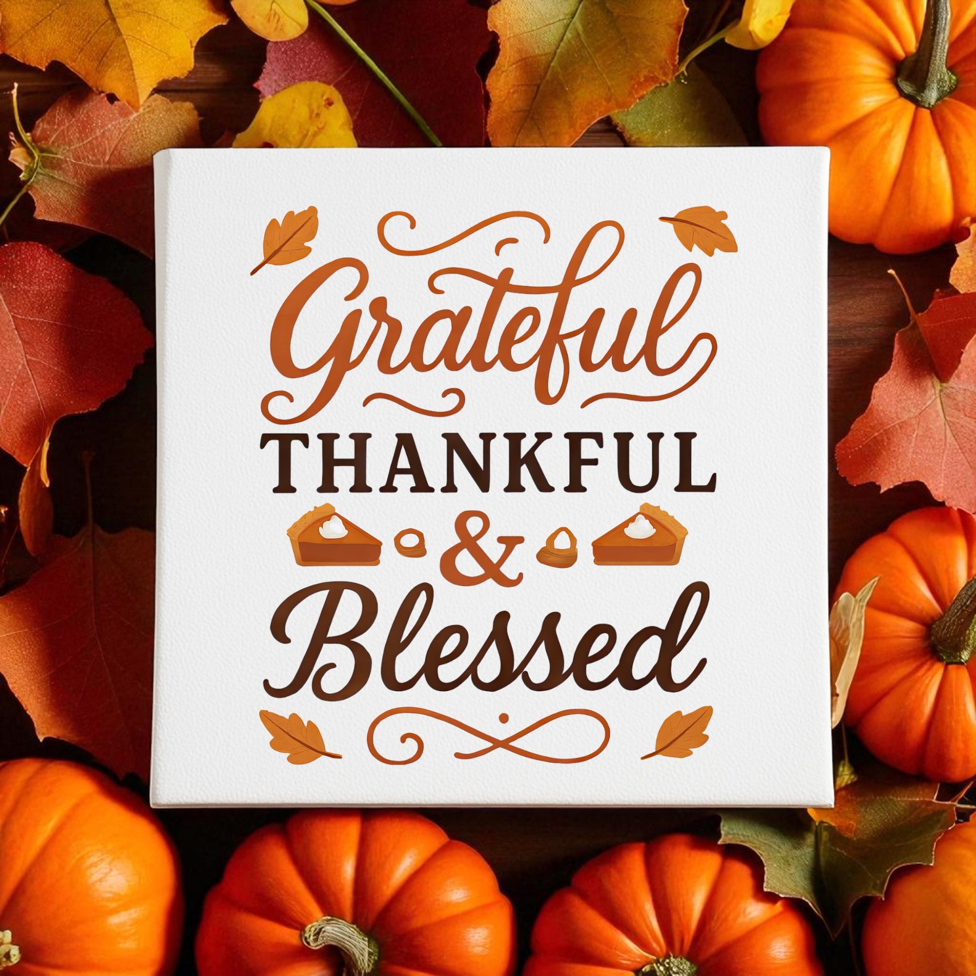 The Grateful Thankful Blessed Canvas by Mirabilia Boutique is an 8x8 fall wall art featuring autumn leaves, pumpkins, and pie slice and leaf illustrations—perfect for adding a festive Thanksgiving touch to your decor.