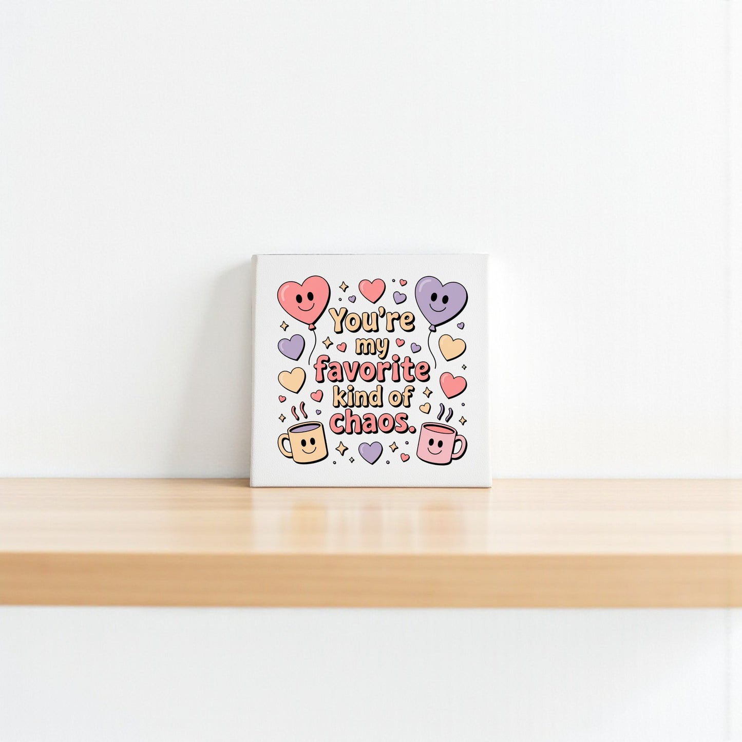 The Mirabilia Boutique "Favorite Kind of Chaos Canvas" features colorful hearts, smiling mugs, and playful text—perfect Valentine’s or Galentine’s gift, or cute decor for a best friend.