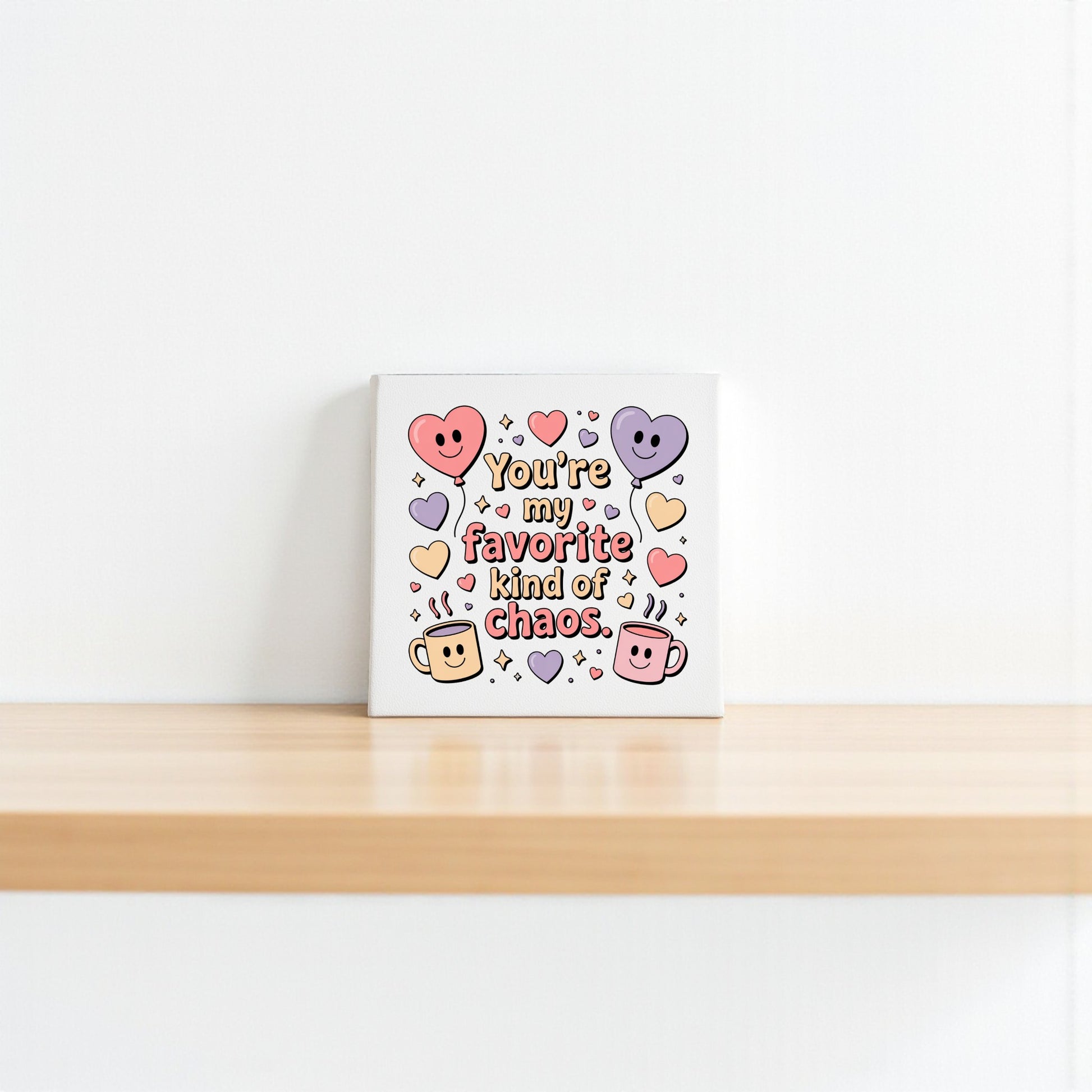 The Mirabilia Boutique "Favorite Kind of Chaos Canvas" features colorful hearts, smiling mugs, and playful text—perfect Valentine’s or Galentine’s gift, or cute decor for a best friend.