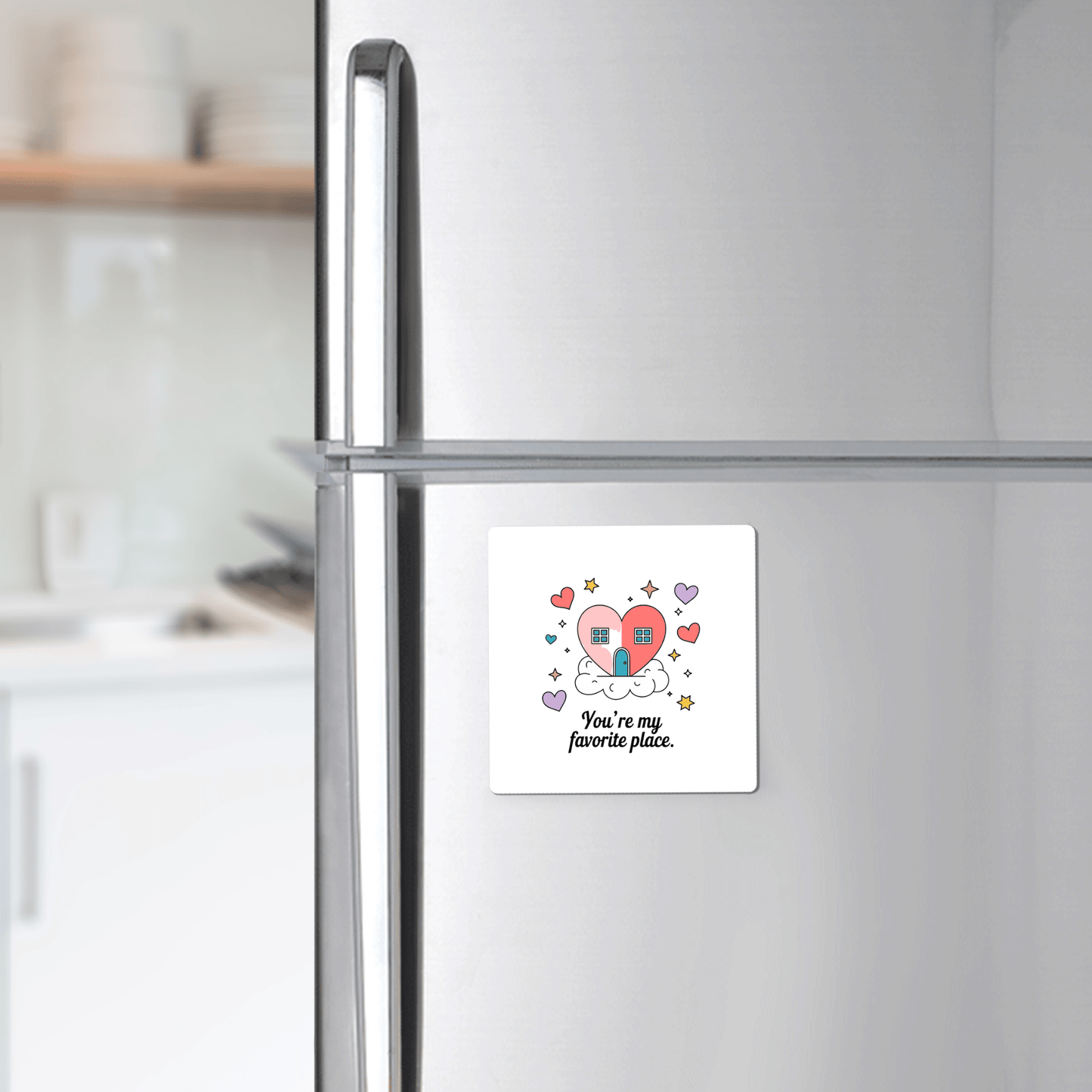 Display the Heart House Magnet by Mirabilia Boutique on your fridge—this adorable magnet features a heart-shaped house, colorful hearts and stars, and the quote "You're My Favorite Place." A thoughtful, sentimental gift for any home.