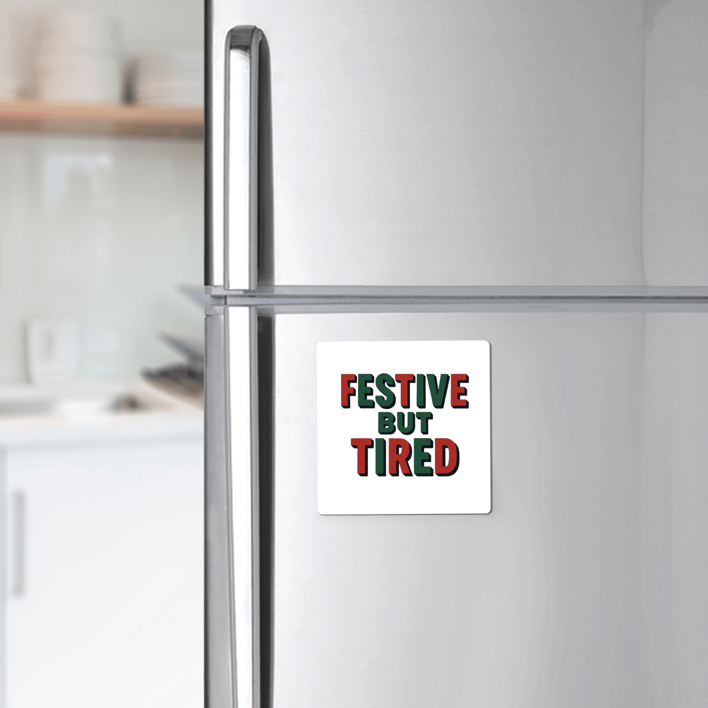 The Mirabilia Boutique Festive But Tired Magnet adds a quirky holiday touch to any silver fridge, featuring red and green lettering—perfect as a funny stocking stuffer or festive gift for the season.