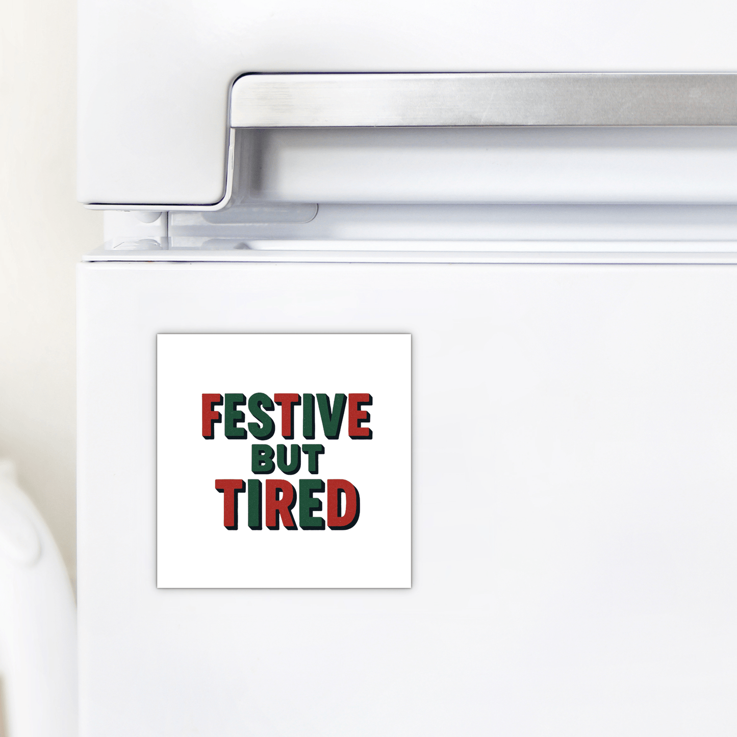 The Festive But Tired Magnet by Mirabilia Boutique features bold green and red text on white—a funny holiday mood gift or stocking stuffer for your fridge this season.