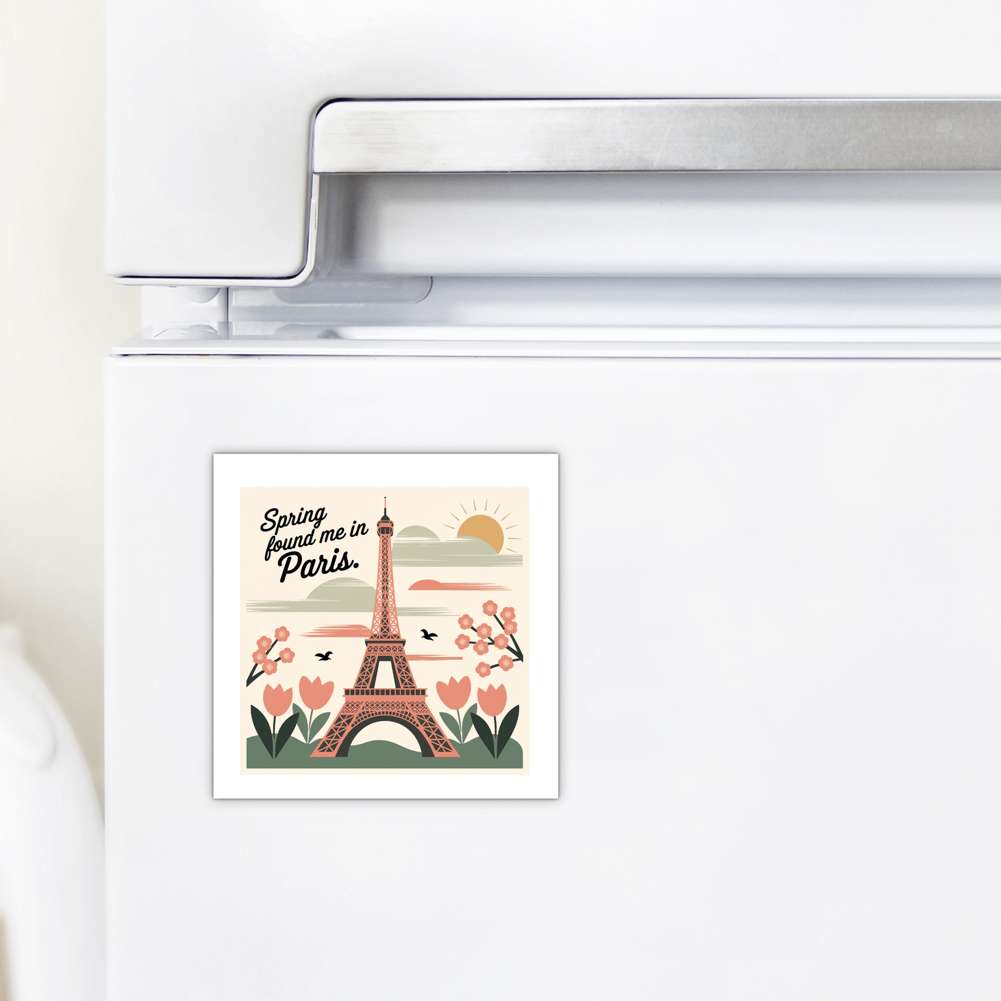 The Mirabilia Boutique "Spring Found Me in Paris Magnet – Eiffel Tower Charm" displays the Eiffel Tower with flowers, hearts, and a sunrise on a white fridge—an enchanting keepsake for spring.