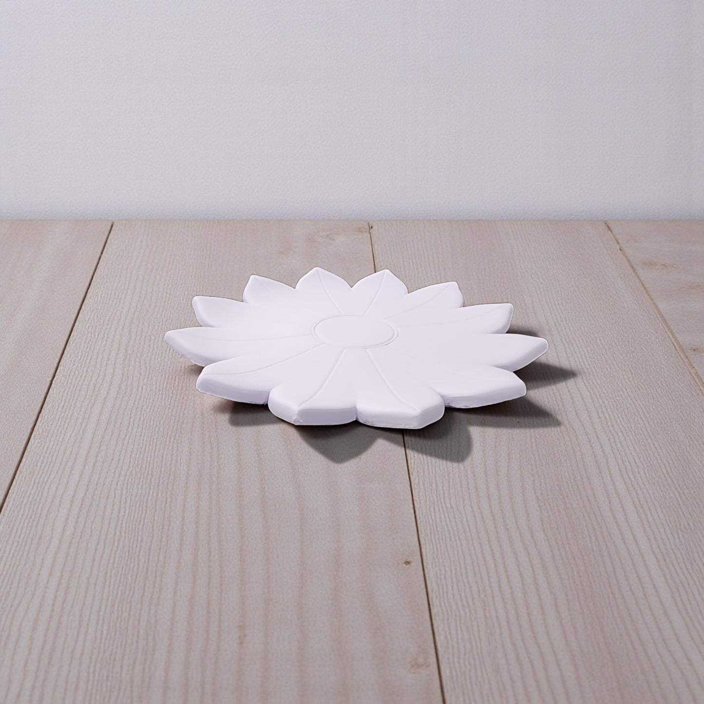 The Spring Bloom Tray by Mirabilia Boutique, a delicate floral accent in white, rests on a light wooden surface with a simple, light-colored backdrop.