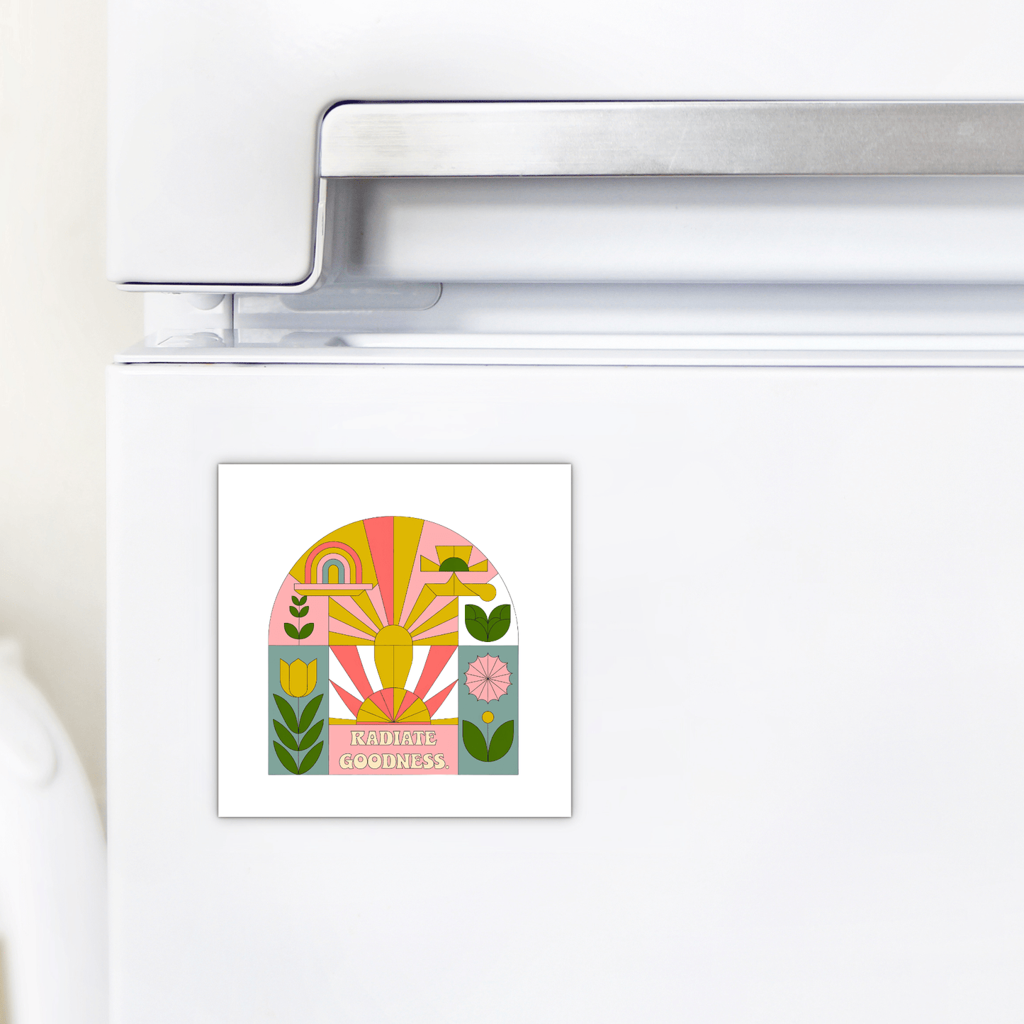 A white refrigerator displays the Mirabilia Boutique Radiate Goodness Colorful Floral Magnet, featuring abstract shapes, plants, a rainbow, and "Radiate Goodness" in bold letters.