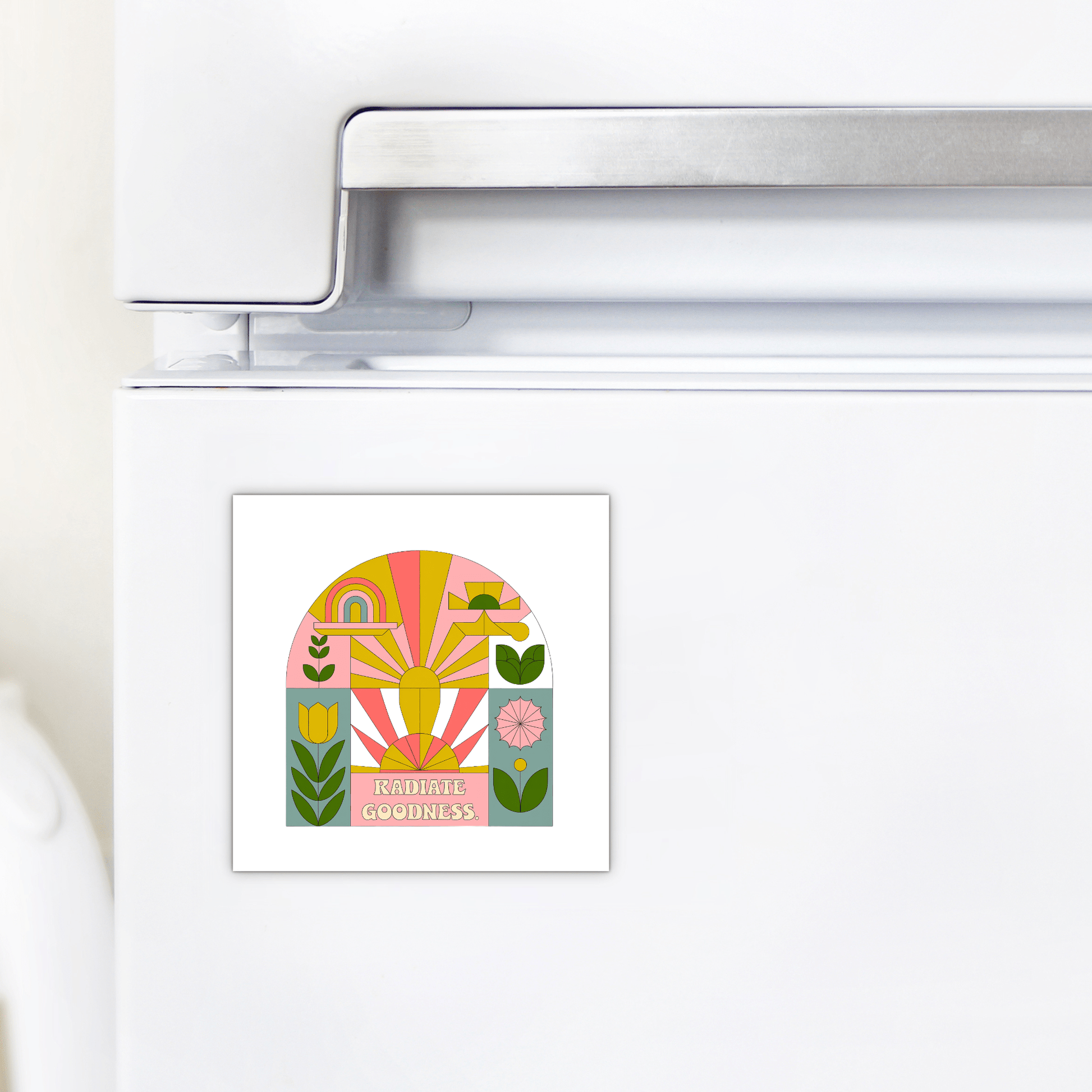 A white refrigerator displays the Mirabilia Boutique Radiate Goodness Colorful Floral Magnet, featuring abstract shapes, plants, a rainbow, and "Radiate Goodness" in bold letters.