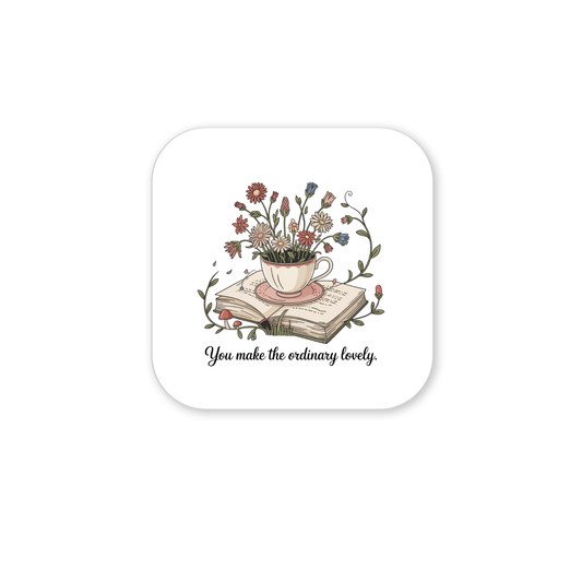 The Floral Teacup Book Magnet by Mirabilia Boutique features a vintage teacup with wildflowers on an open book, with the phrase "You make the ordinary lovely"—a soft, whimsical design perfect for an inspirational gift.