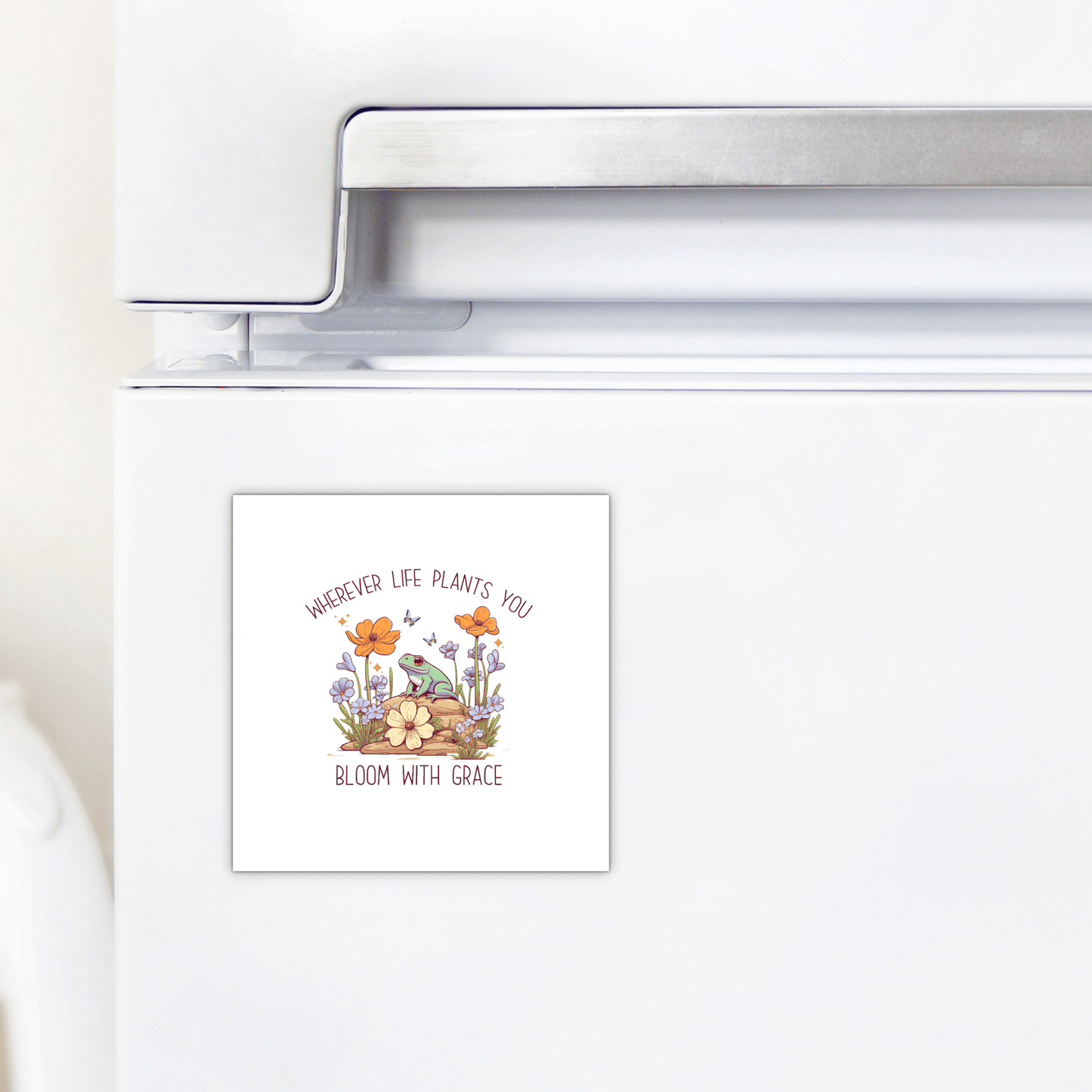 The Frog Magnet by Mirabilia Boutique features "Bloom With Grace," making it a cute inspirational decor piece and a thoughtful gift for any fridge.