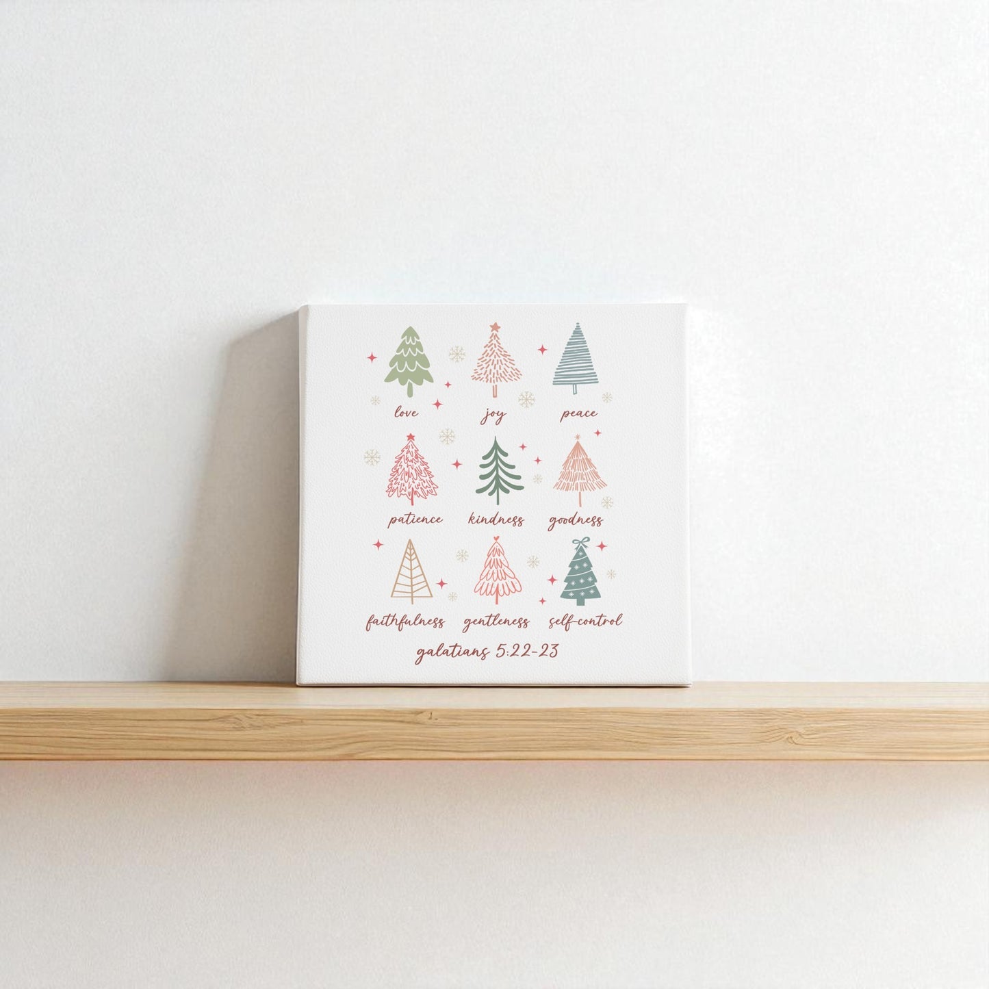 The "Fruits of the Spirit" canvas by Mirabilia Boutique features hand-drawn Christmas trees, words like "love," "joy," and Galatians 5:22—making it a perfect Christian Christmas gift and meaningful holiday decor.