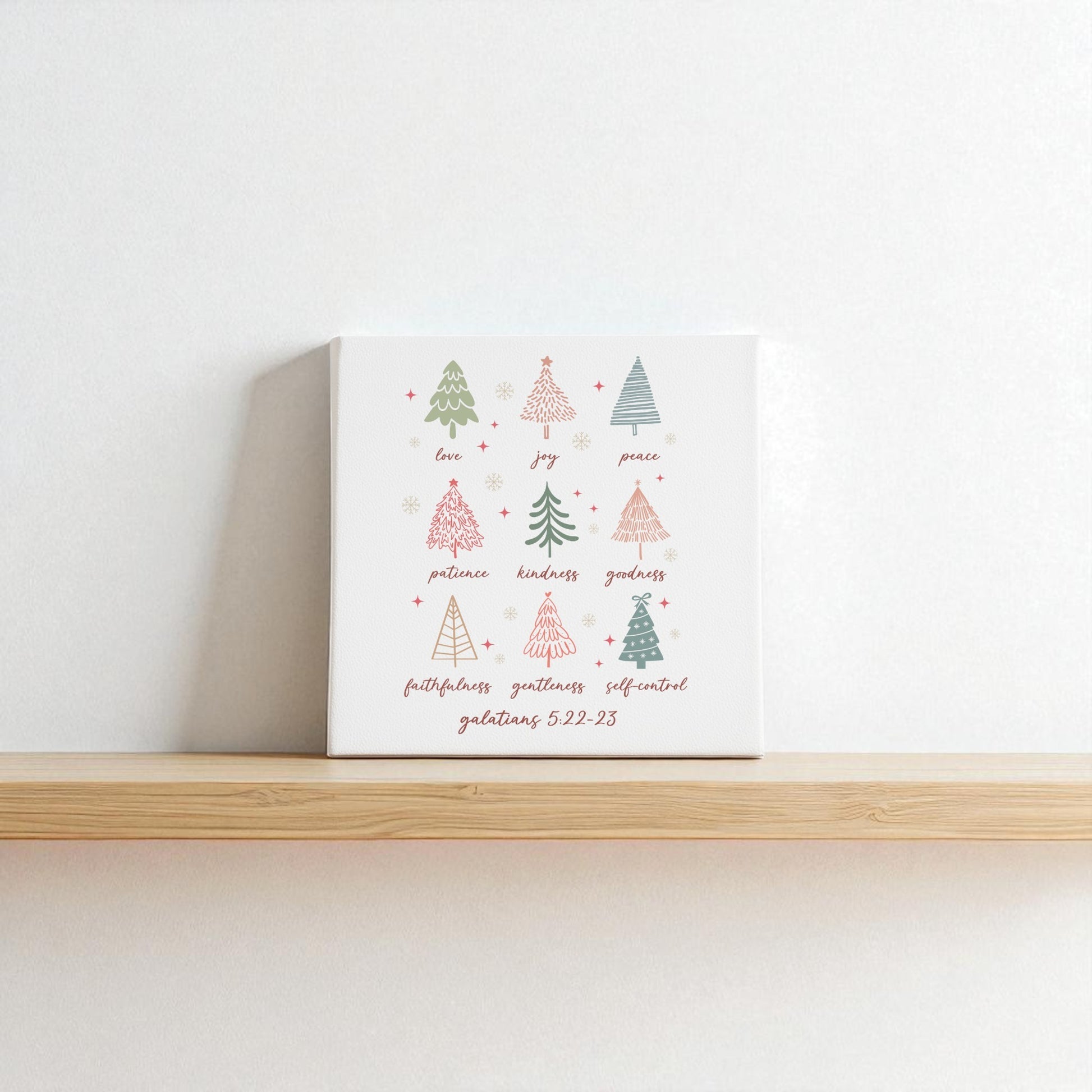 The "Fruits of the Spirit" canvas by Mirabilia Boutique features hand-drawn Christmas trees, words like "love," "joy," and Galatians 5:22—making it a perfect Christian Christmas gift and meaningful holiday decor.