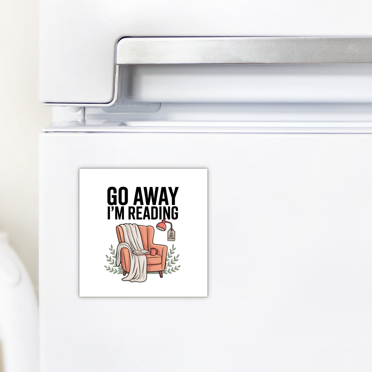 The Go Away I'm Reading Magnet by Mirabilia Boutique is a funny fridge magnet for book lovers, featuring a cozy armchair, lamp, books, and the phrase "GO AWAY I'M READING"—a perfect gift for readers.
