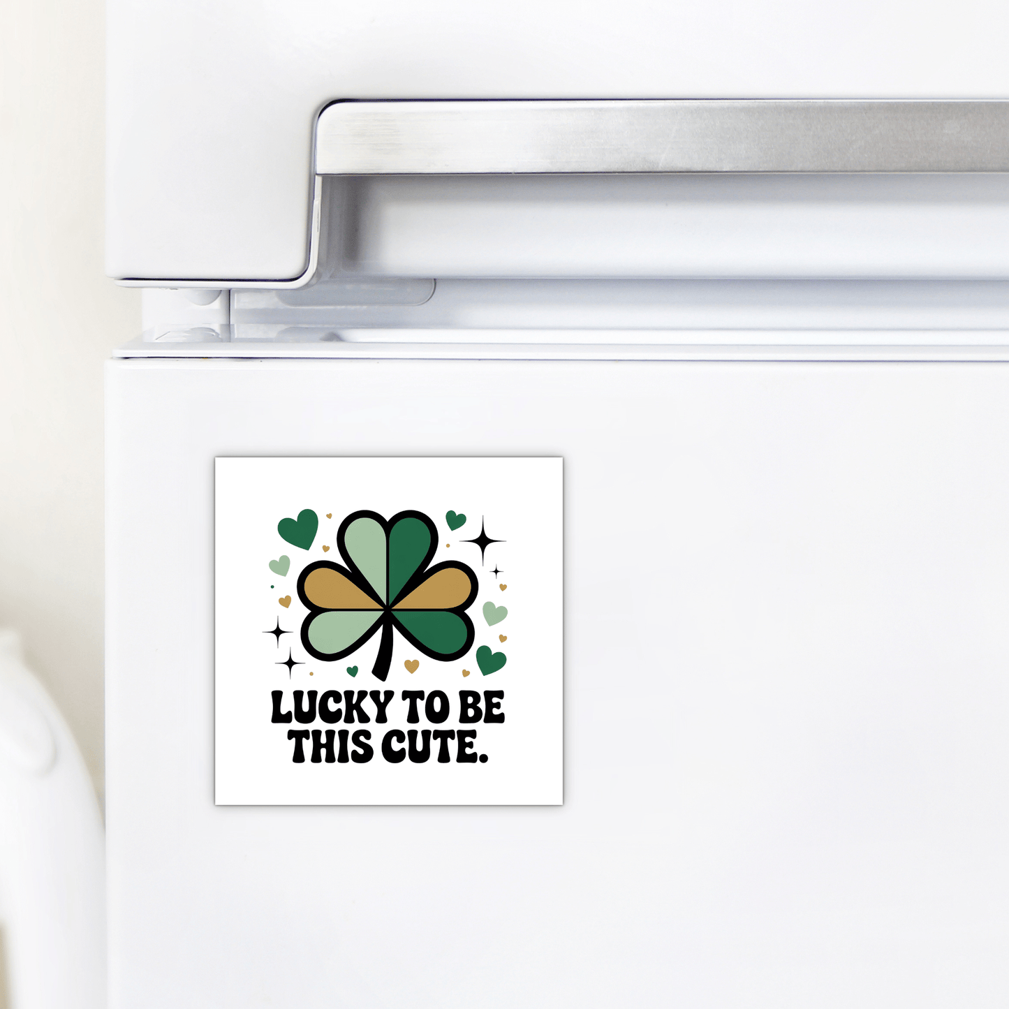 The Lucky to Be This Cute Magnet by Mirabilia Boutique is a square fridge magnet with a green and gold shamrock, hearts, and "Lucky to be this cute" text—an ideal St. Patrick's Day clover gift for any celebration.