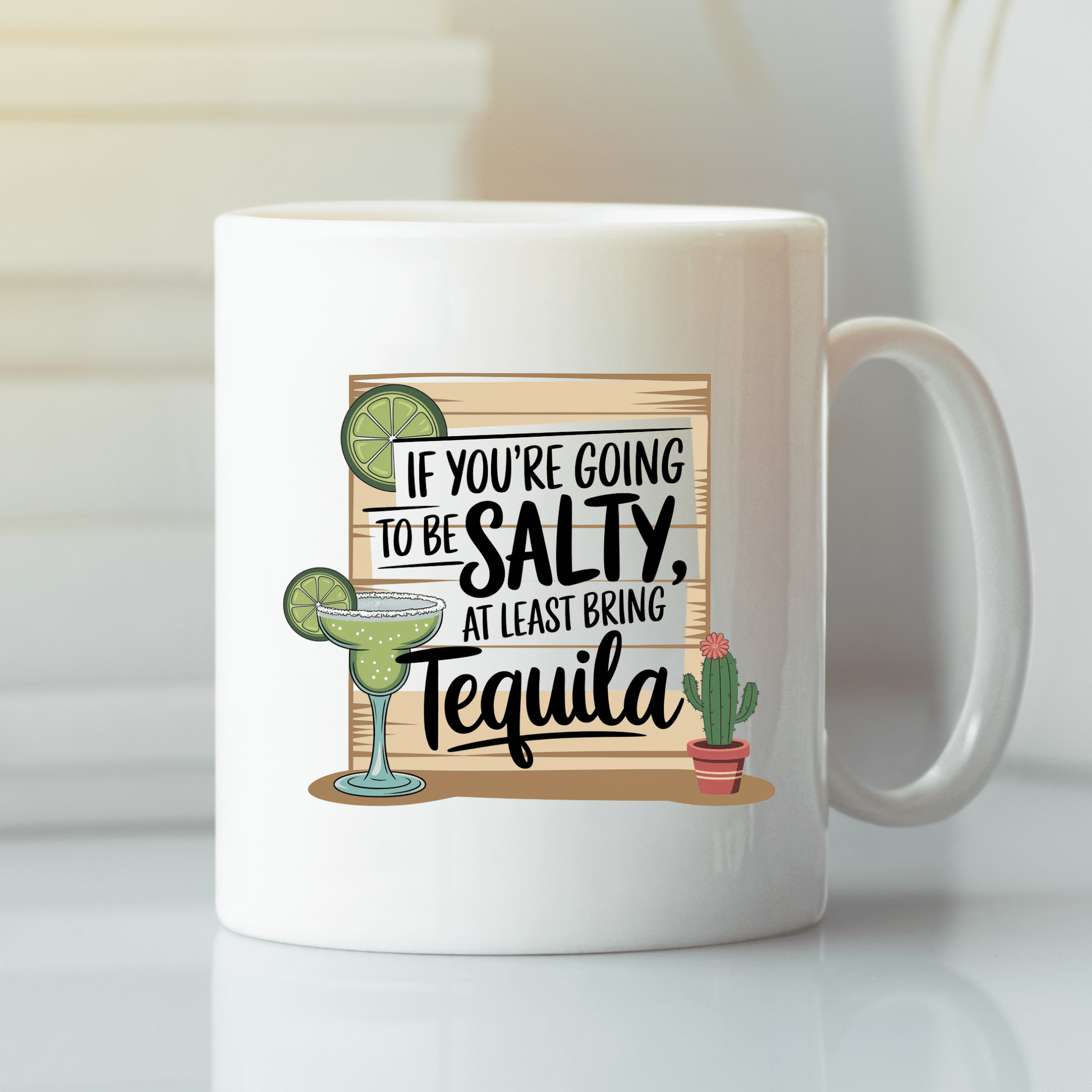 The Salty Tequila Mug by Mirabilia Boutique is a funny coffee cup with a margarita, cactus, and the quote "If you're going to be salty, at least bring tequila"—a perfect way to add playful spirit to your morning.