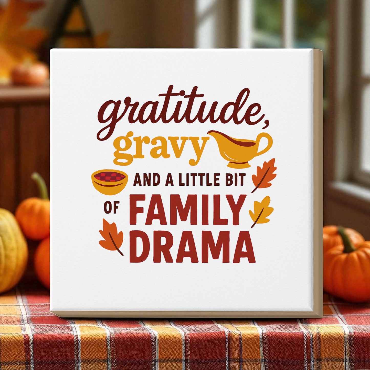 The Gratitude Gravy & Family Drama 8x8 Canvas by Mirabilia Boutique features a humorous Thanksgiving quote with pie and leaf art. Ideal as festive décor or a unique family gathering gift.