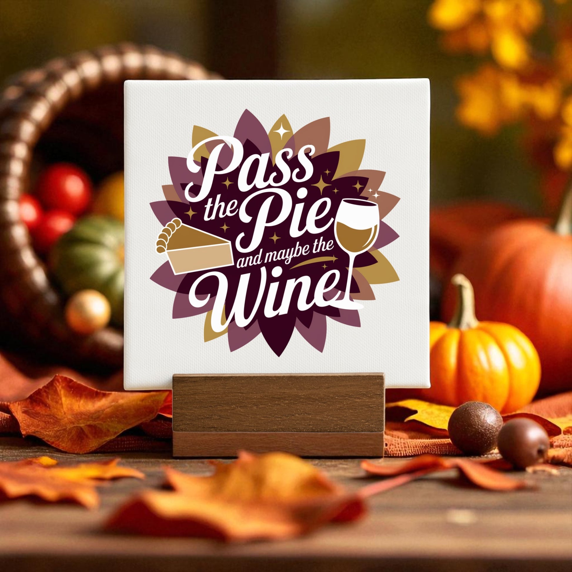 The Pass the Pie and Maybe the Wine Mini Fall Sign by Mirabilia Boutique features festive pie and wine art—ideal Thanksgiving decor or a fun fall gift for wine lovers, perfect for your autumn table.