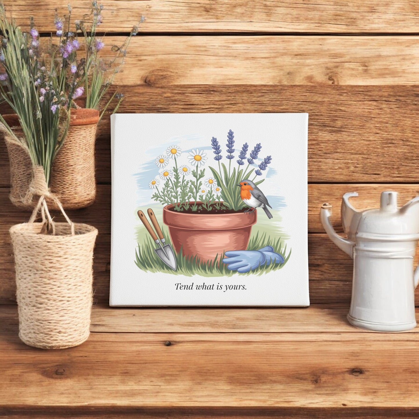 The Mirabilia Boutique Tend What Is Yours Canvas Sign – 8x8 Garden Art features garden tools, flowers, and a robin with the quote “Tend what is yours”—a mindful decor piece perfect for wooden shelves, potted lavender, or woven baskets.