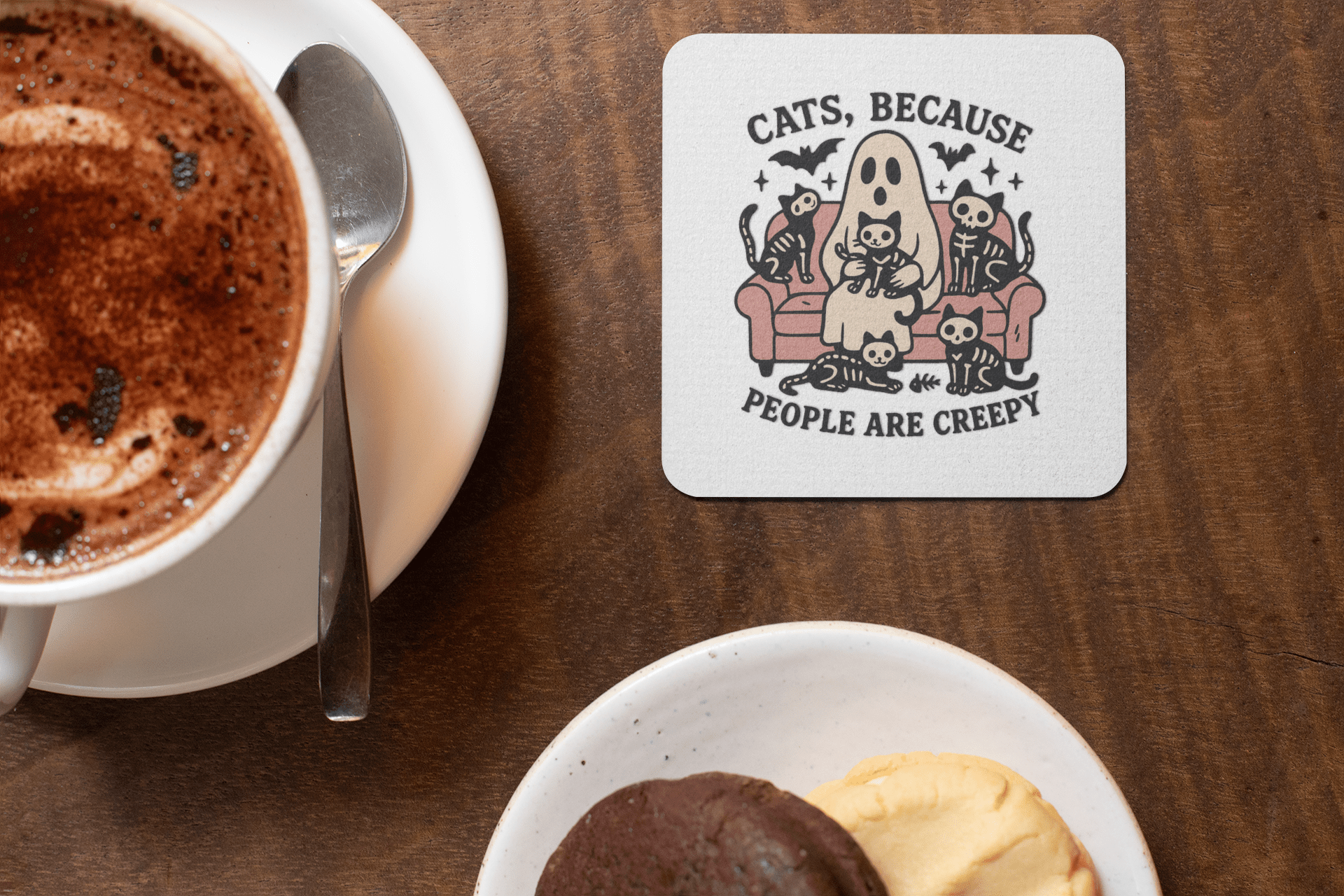 The Mirabilia Boutique "Funny Ghost Cat Coaster | Cats Because People Are Creepy" features a cartoon ghost and cats on a couch—an adorable, spooky gift for cat lovers, perfect for your coffee table beside hot chocolate and cookies.