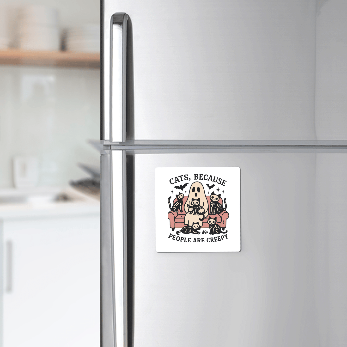 A refrigerator with the Mirabilia Boutique Funny Ghost Cat Magnet featuring a person in a cat costume, three cats on a couch, and the text, "Cats Because People Are Creepy.