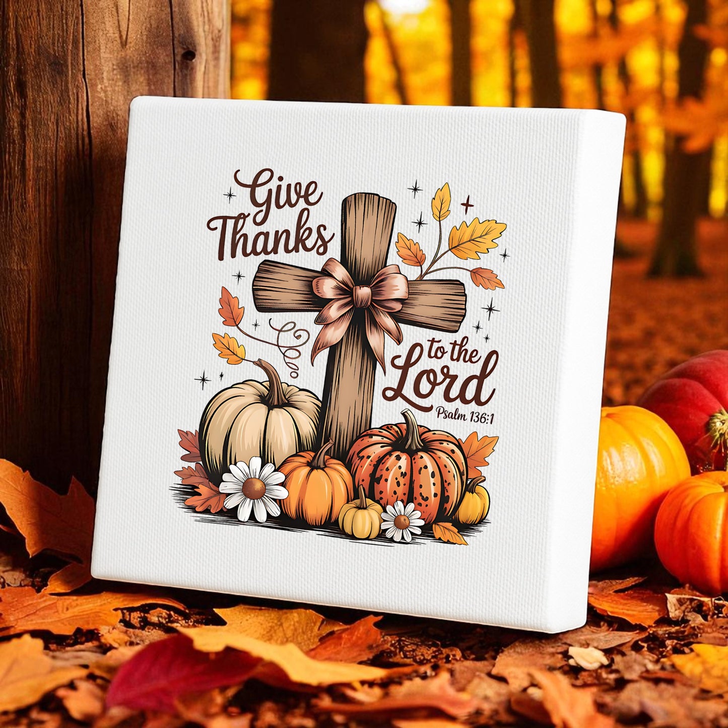 The Mirabilia Boutique Thanksgiving Canvas features a wooden cross with "Give Thanks to the Lord" (Psalm 136:1), pumpkins, and autumn leaves—perfect fall decor for Christian homes or as Thanksgiving wall art.
