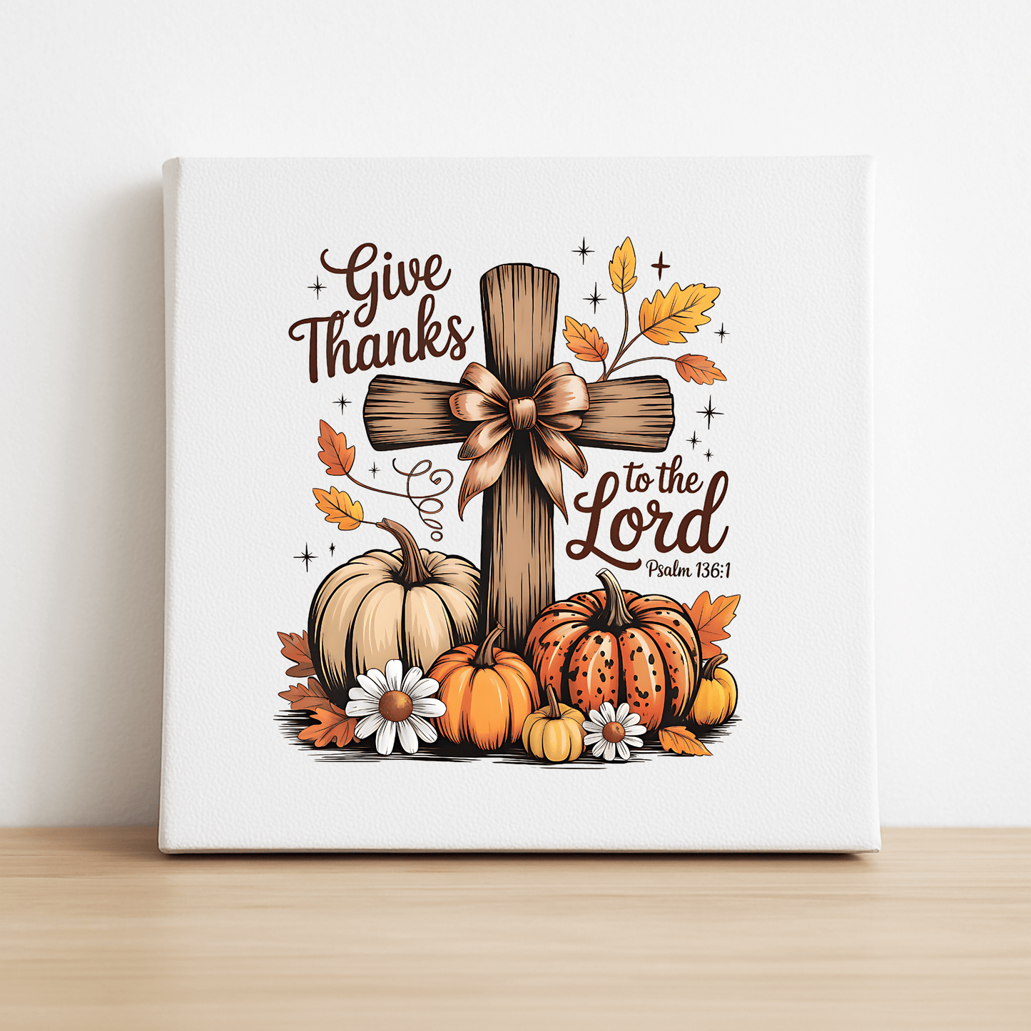 The Thanksgiving Canvas | Give Thanks Cross by Mirabilia Boutique features Psalm 136:1 and autumn motifs, making it perfect fall décor to inspire gratitude and warmth.