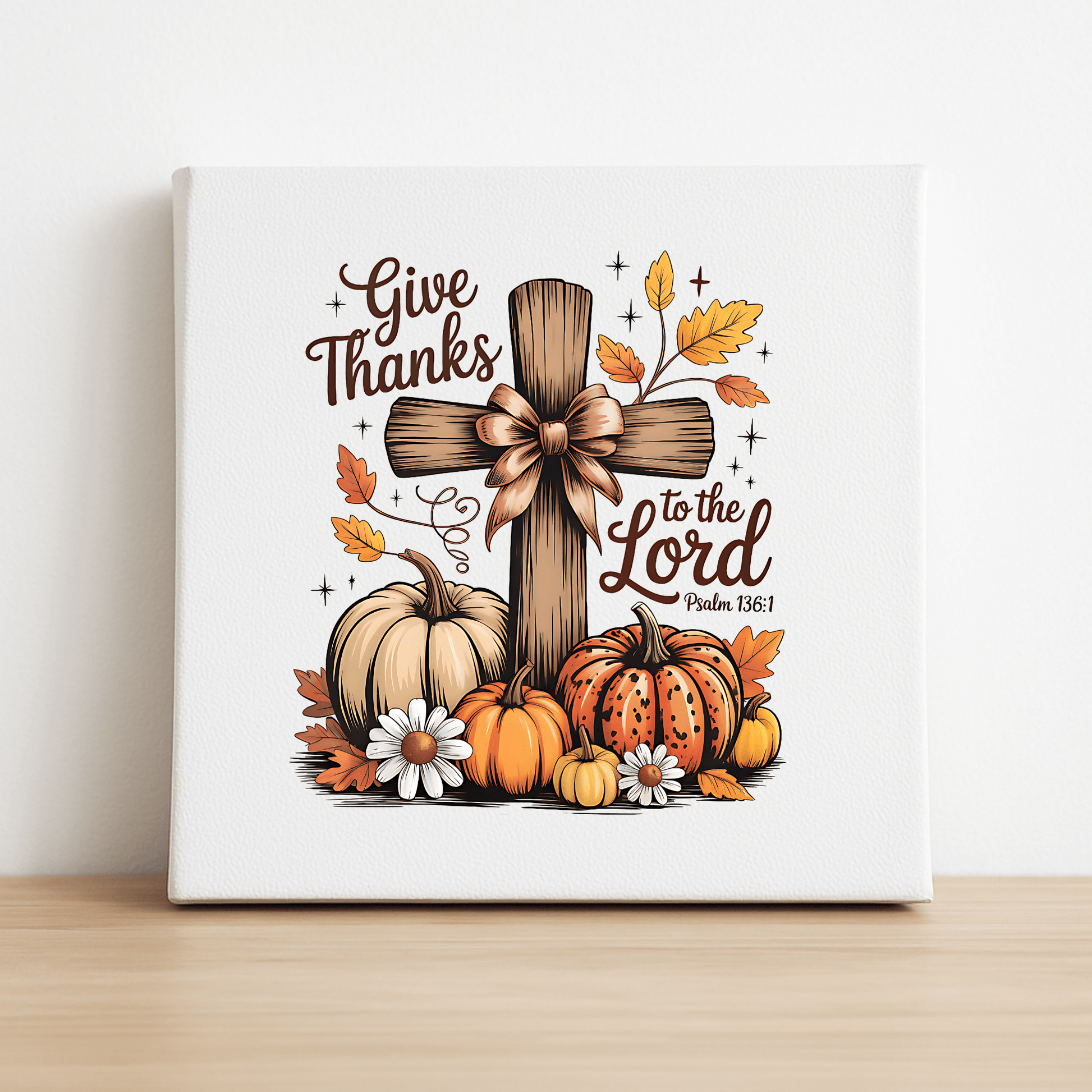 The Thanksgiving Canvas | Give Thanks Cross by Mirabilia Boutique features Psalm 136:1 and autumn motifs, making it perfect fall décor to inspire gratitude and warmth.