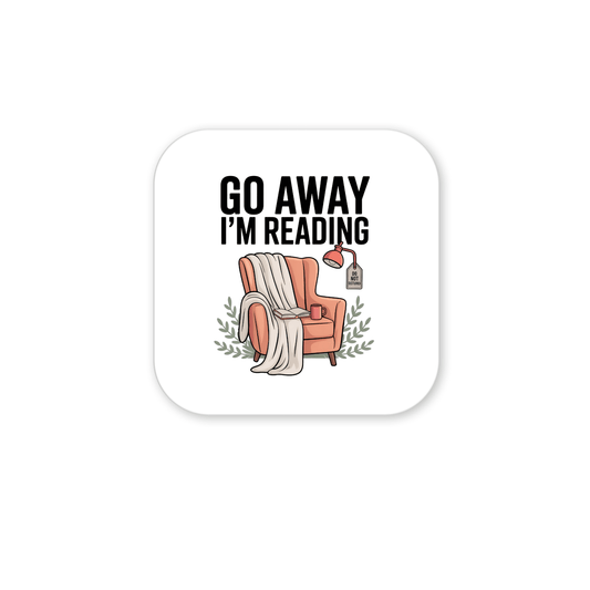 The "Go Away I'm Reading Magnet" by Mirabilia Boutique features a cozy armchair with a blanket, books, mug, lamp, and green leaves. Bold text says “GO AWAY I’M READING”—the perfect funny book lover gift for any fridge!.