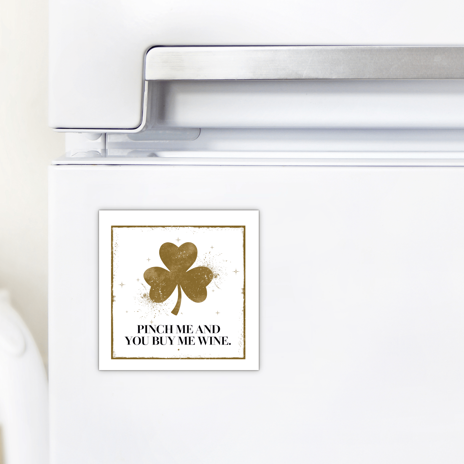 A white fridge displays the Mirabilia Boutique "Pinch Me and You Buy Me Wine Magnet"—a square magnet with a gold shamrock and fun text, making it a perfect St. Patrick’s Day gift for wine lovers.