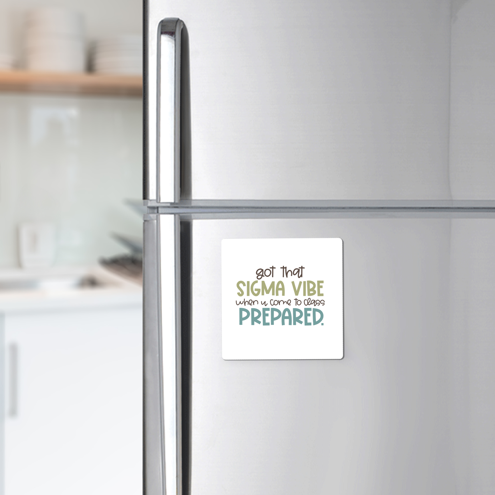 The Mirabilia Boutique Got That Sigma Vibe Classroom Magnet, shown on a stainless steel fridge with a modern kitchen background, reads "got that SIGMA VIBE when it comes to being PREPARED." Great for motivation or teacher appreciation.
