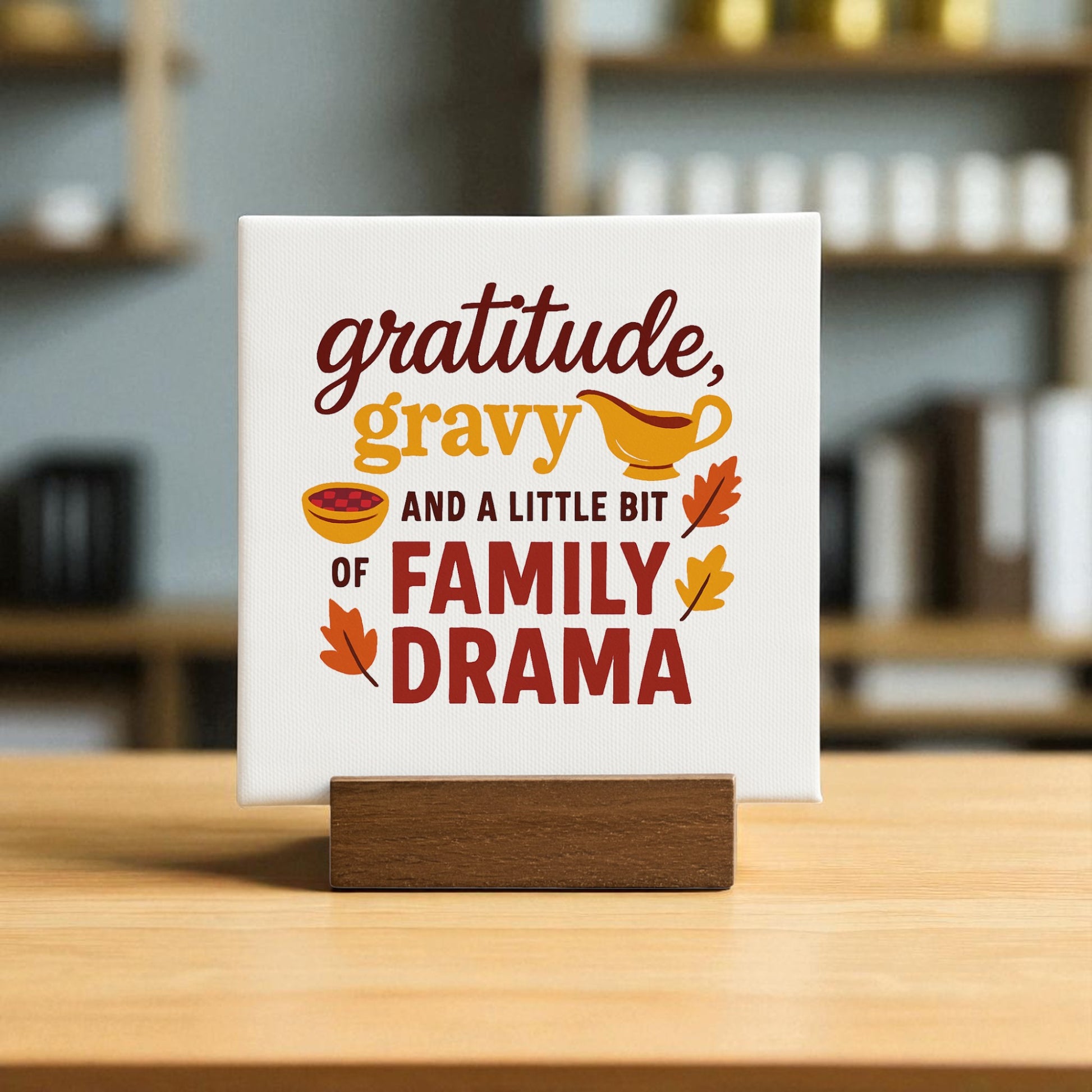 The Gratitude Gravy & Drama mini sign by Mirabilia Boutique features a fun Thanksgiving message with a gravy boat and autumn leaves—perfect for cozy fall or Thanksgiving decor in any room.