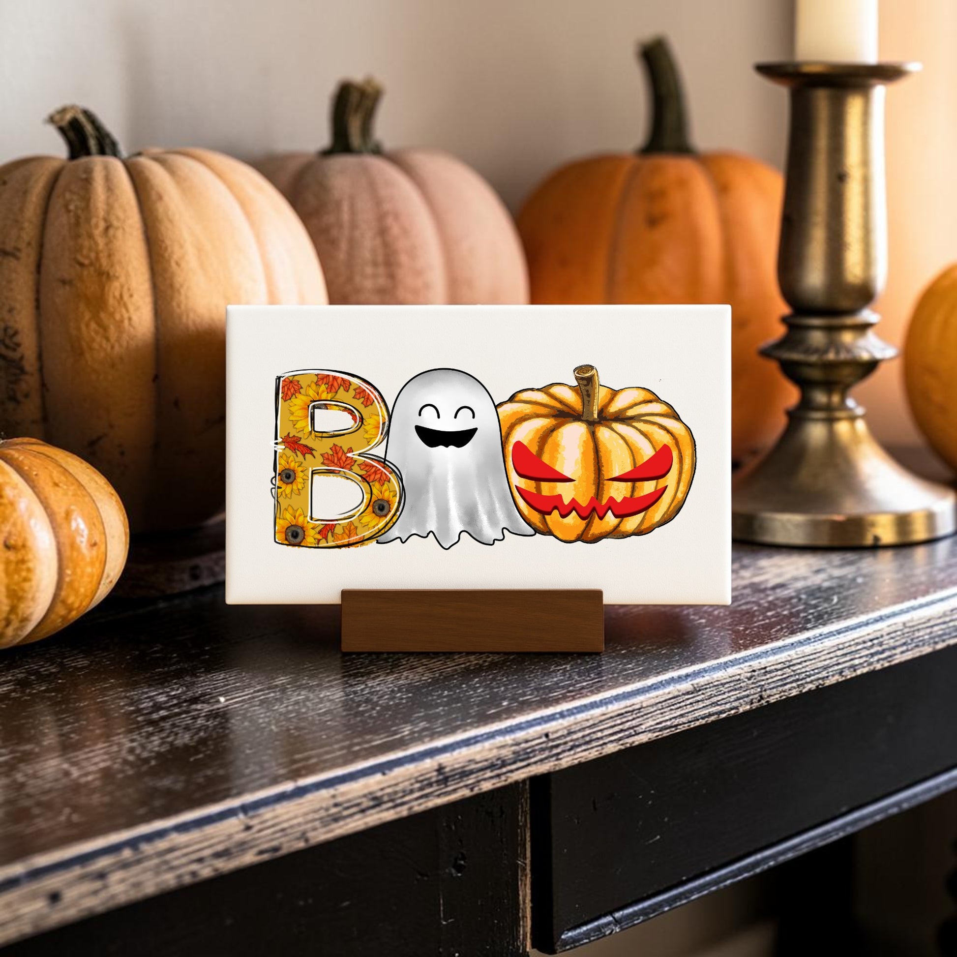 The BOO Ghost Pumpkin Mini Sign from Mirabilia Boutique features a floral "B," ghost "O," and pumpkin "O" on a stand—perfect Halloween shelf decor or autumn accent for your table.