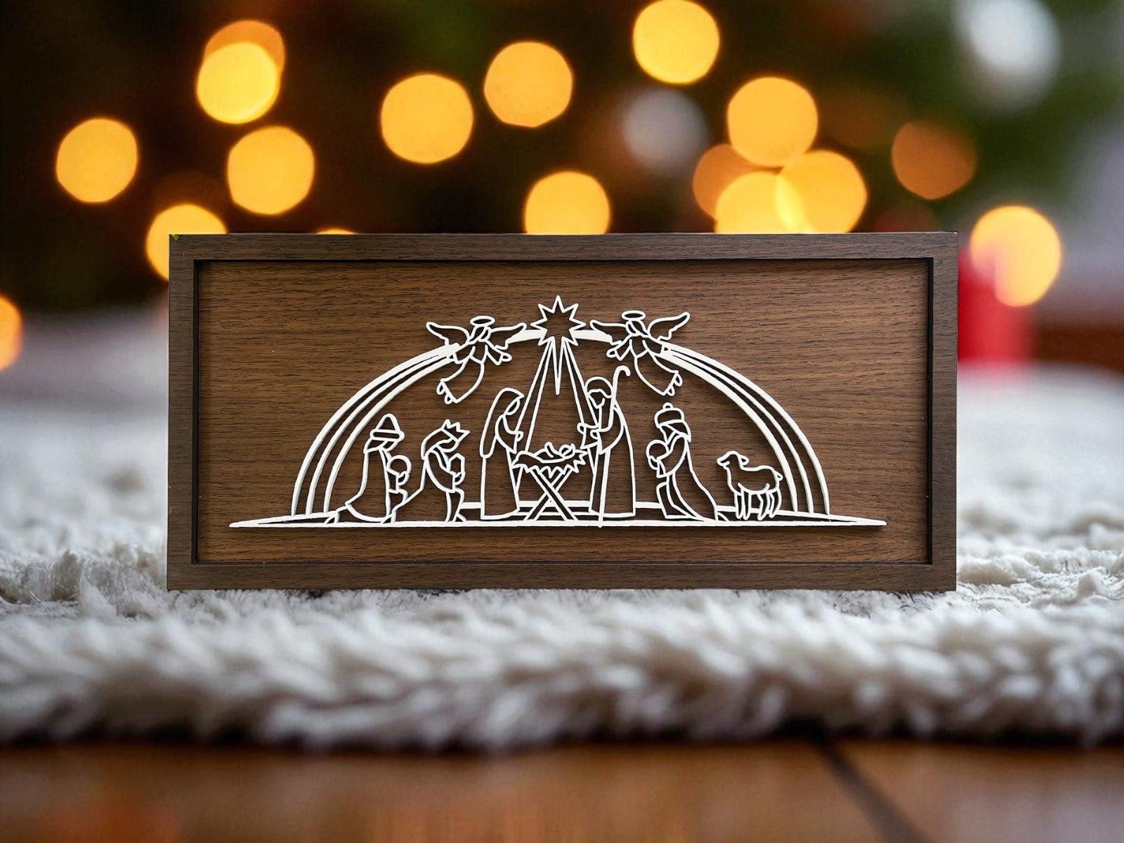 The Mirabilia Boutique Laser Cut Nativity Sign is a handmade 9x4 wooden plaque with white line art of Mary, Joseph, baby Jesus, wise men, shepherds, angels, and a sheep—perfect for glowing Christmas decor.