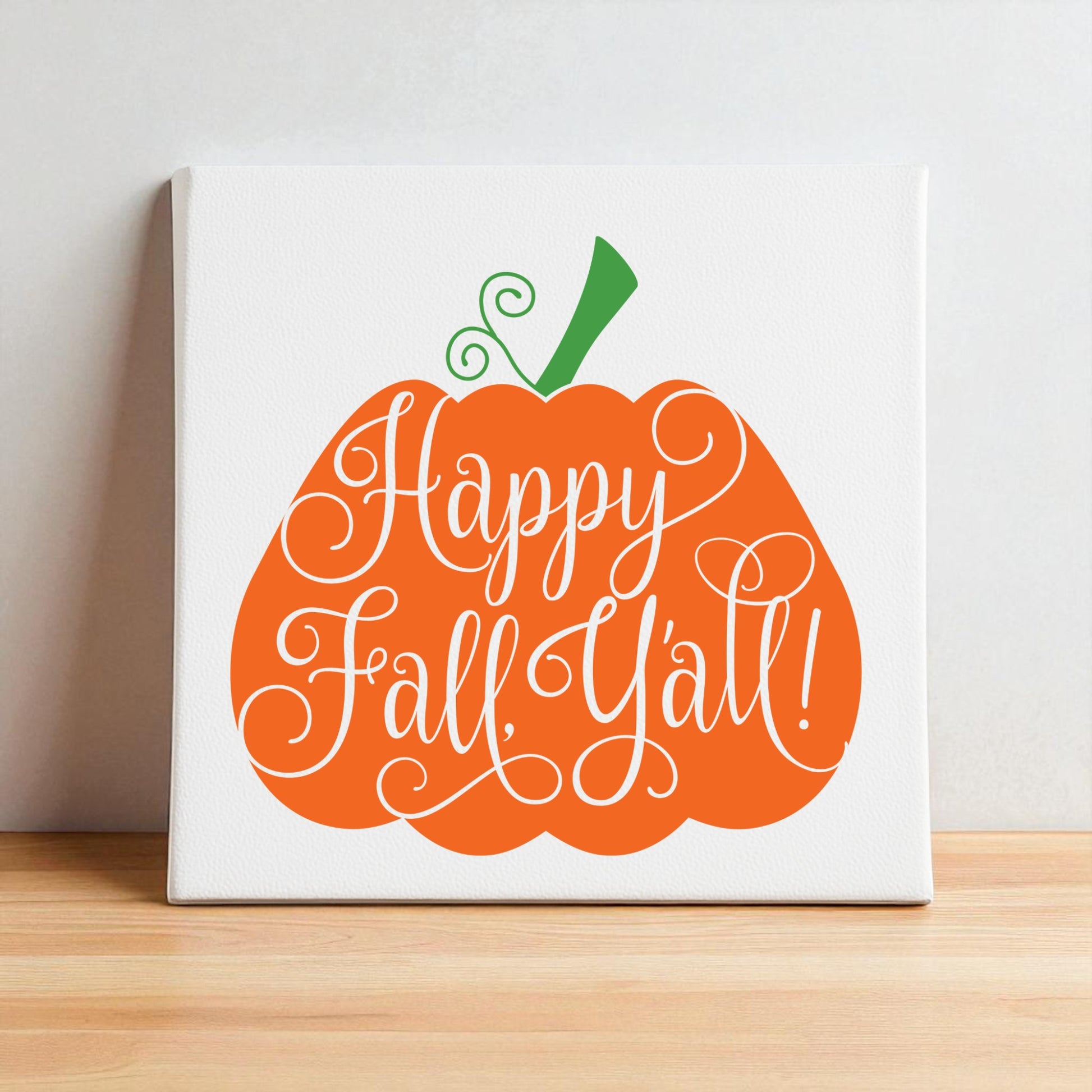 The Happy Fall Y’all Pumpkin Wall Art by Mirabilia Boutique features an orange pumpkin with a green stem and "Happy Fall, Y'all!" script, adding southern autumn charm to your home decor.