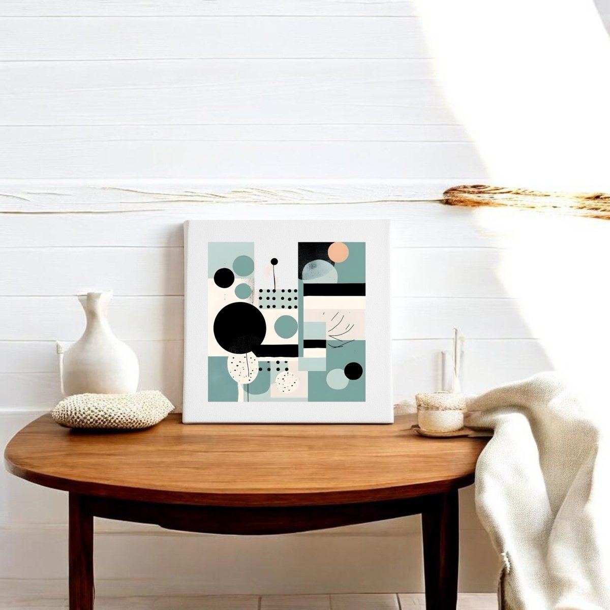 The Harbor Morning Mid Century Modern Canvas by Mirabilia Boutique sits framed on a wooden table with a white vase and woven coaster, set against a sunlit white paneled wall.