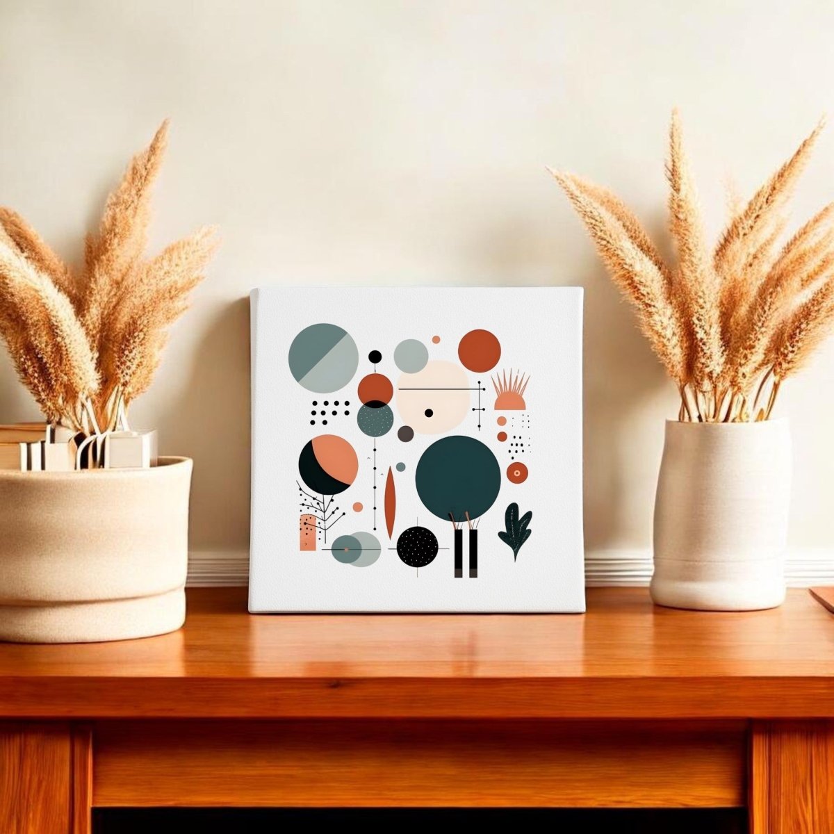 A modern wooden table with two beige vases of dried pampas grass flanking the Harvest Sun Mid Century Modern Canvas by Mirabilia Boutique, featuring geometric botanical art in muted tones against a plain light wall.