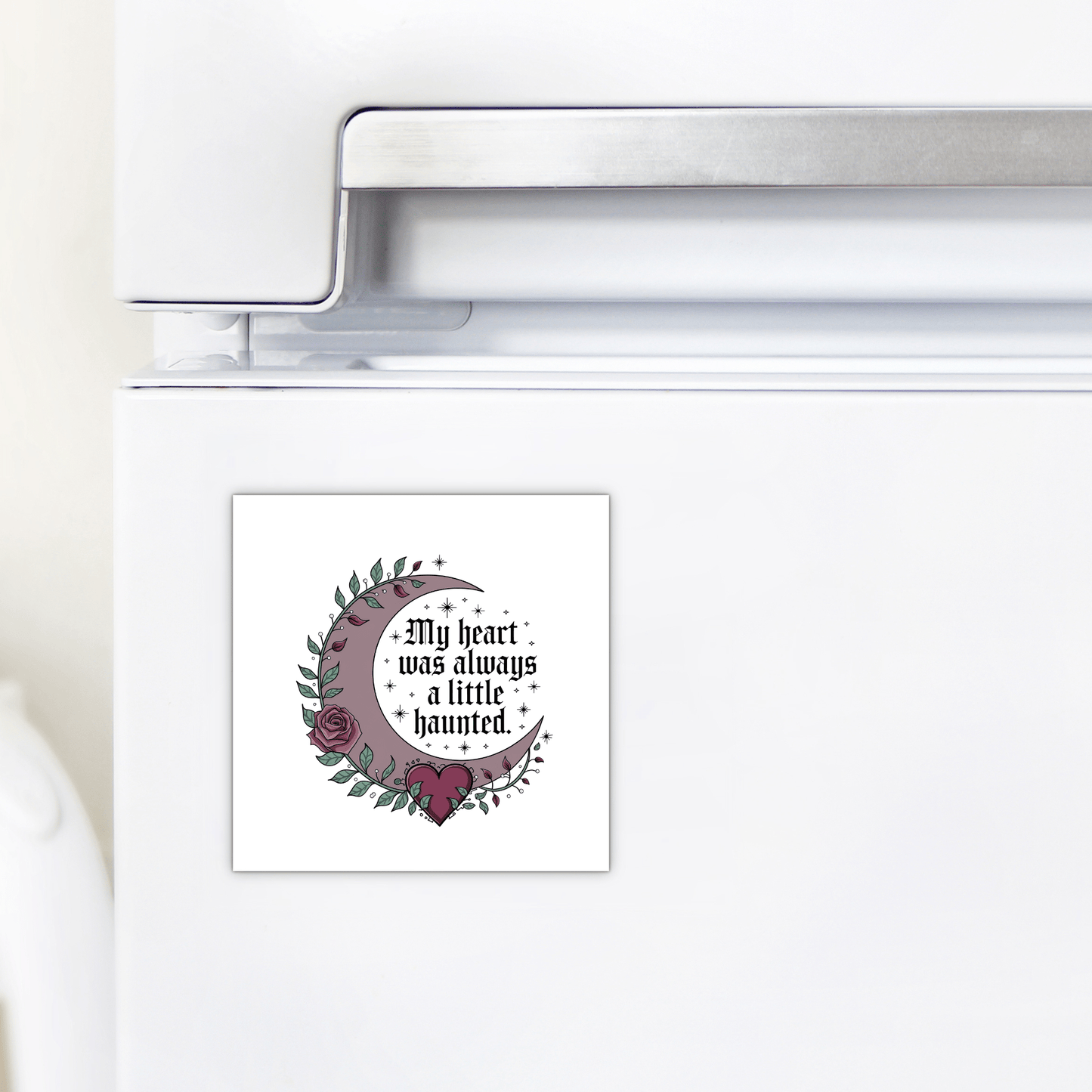 The Mirabilia Boutique Gothic Fridge Magnet features a haunted heart crescent moon design with roses and stars and the quote "My heart was always a little haunted"—the perfect gothic home decor accent.