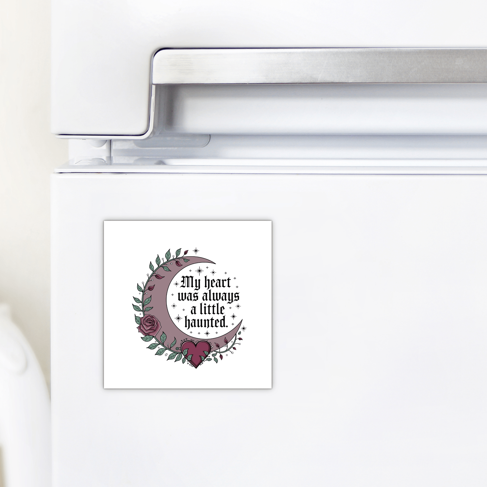 The Mirabilia Boutique Gothic Fridge Magnet features a haunted heart crescent moon design with roses and stars and the quote "My heart was always a little haunted"—the perfect gothic home decor accent.
