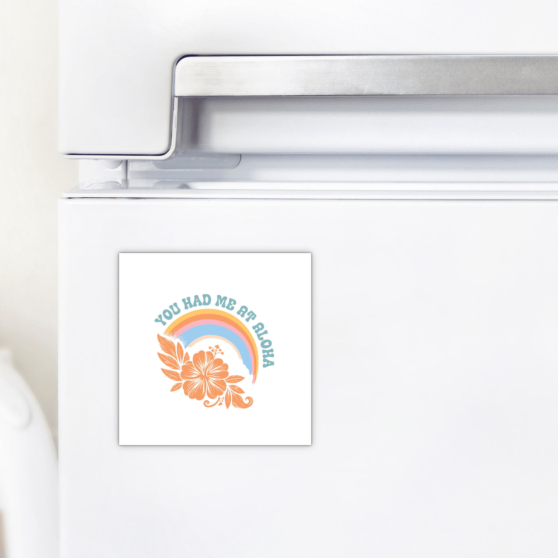 The You Had Me at Aloha Magnet – Tropical Rainbow & Hibiscus by Mirabilia Boutique features a vibrant hibiscus, pastel rainbow, and the phrase "YOU HAD ME AT ALOHA"—a perfect tropical accent for your beach house fridge.