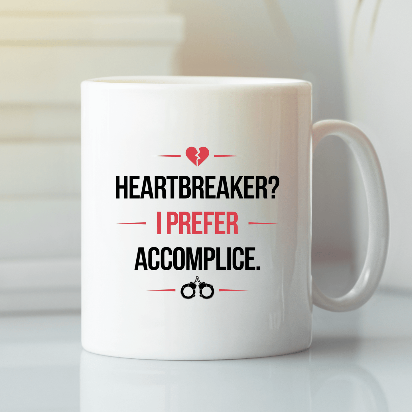 The Heartbreaker Mug from Mirabilia Boutique features "Heartbreaker? I prefer accomplice." with bold graphics—a flirty couples gift or partner in crime mug, perfect for Valentine’s Day or sharing with your special someone.