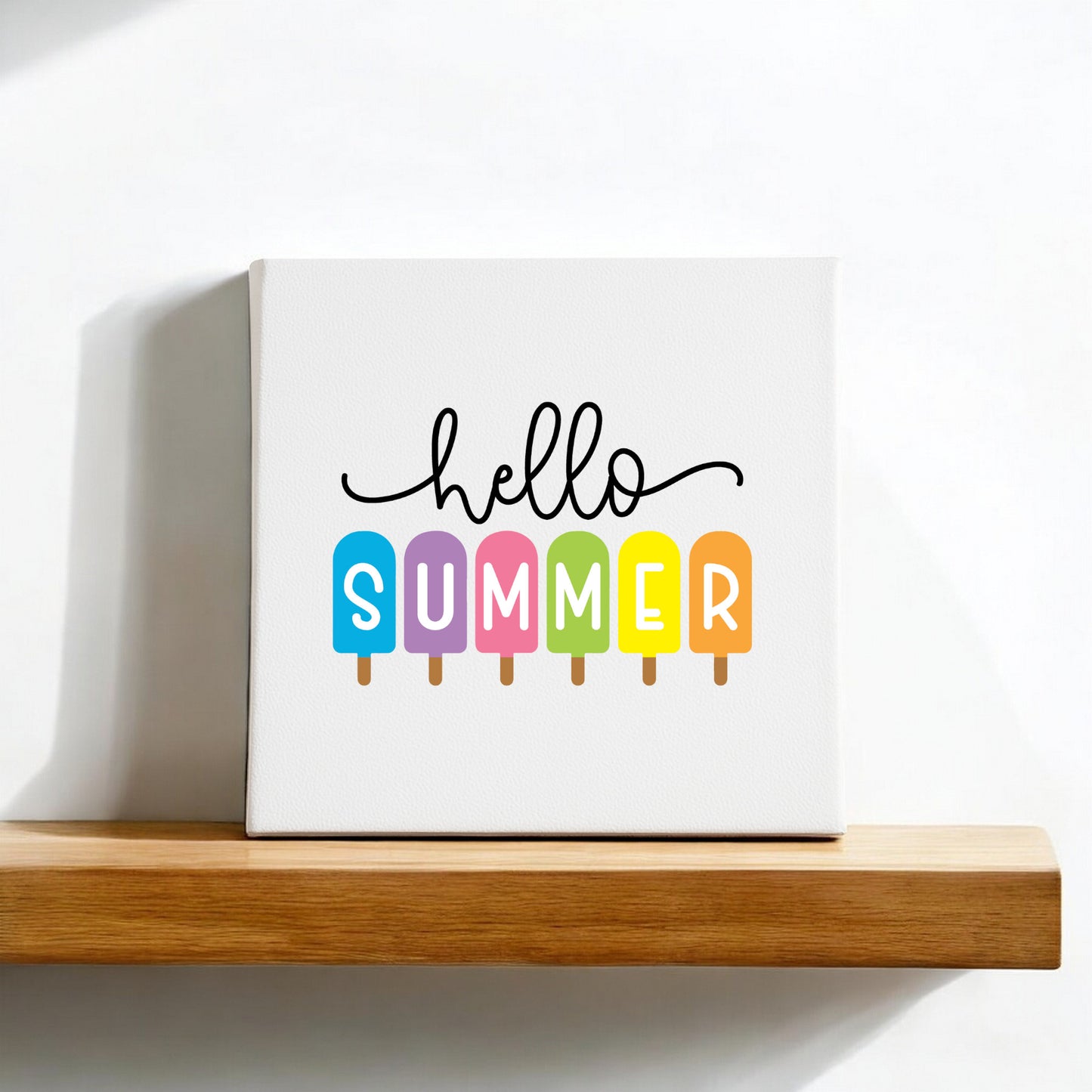The Mirabilia Boutique Hello Summer Popsicle Canvas Sign (8x8) features “summer” spelled on colorful popsicles, adding playful seasonal charm to your wall decor.