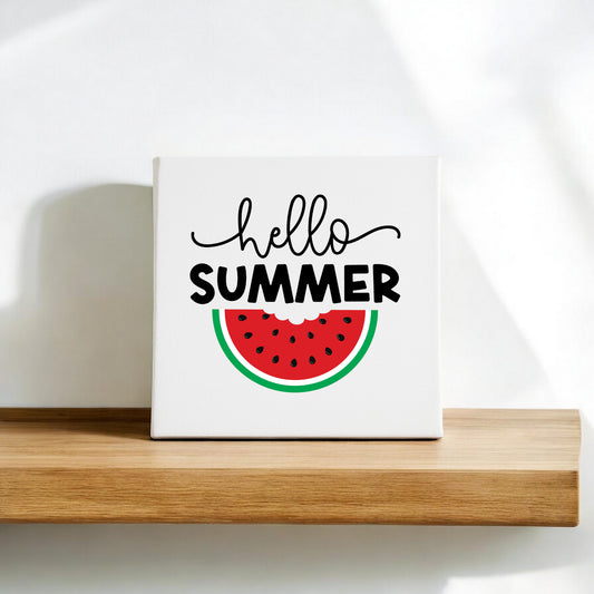 The Hello Summer Watermelon Canvas Sign by Mirabilia Boutique is an 8x8 fruit wall art piece featuring "hello SUMMER" and a watermelon slice—ideal for adding a cheerful, seasonal touch to your space.