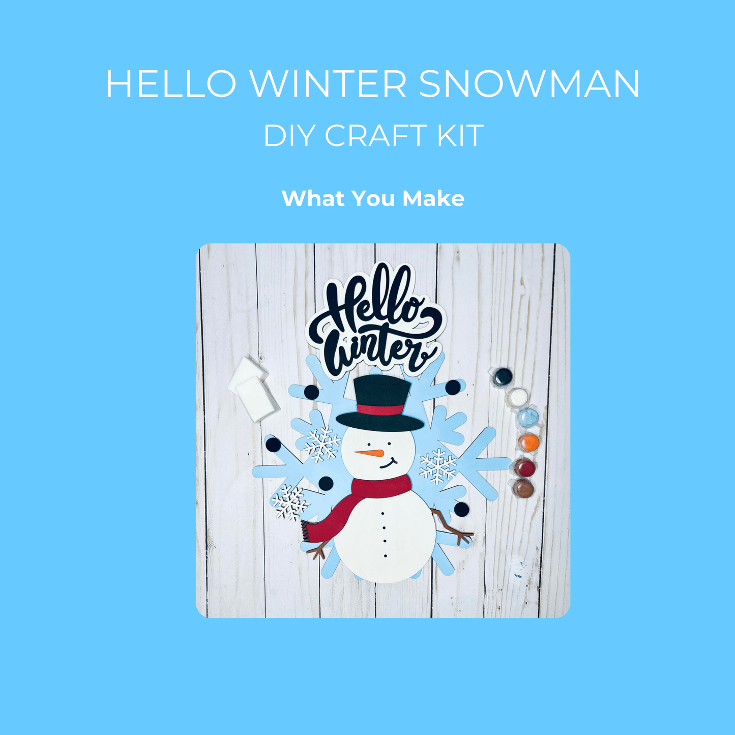 Flat lay of the Mirabilia Boutique "Hello Winter Snowman DIY Kit | Paint Your Own Wood Sign" featuring paint pots, brush, snowman and snowflake wood shapes, and a small wooden sign—all perfect for creating winter decor.