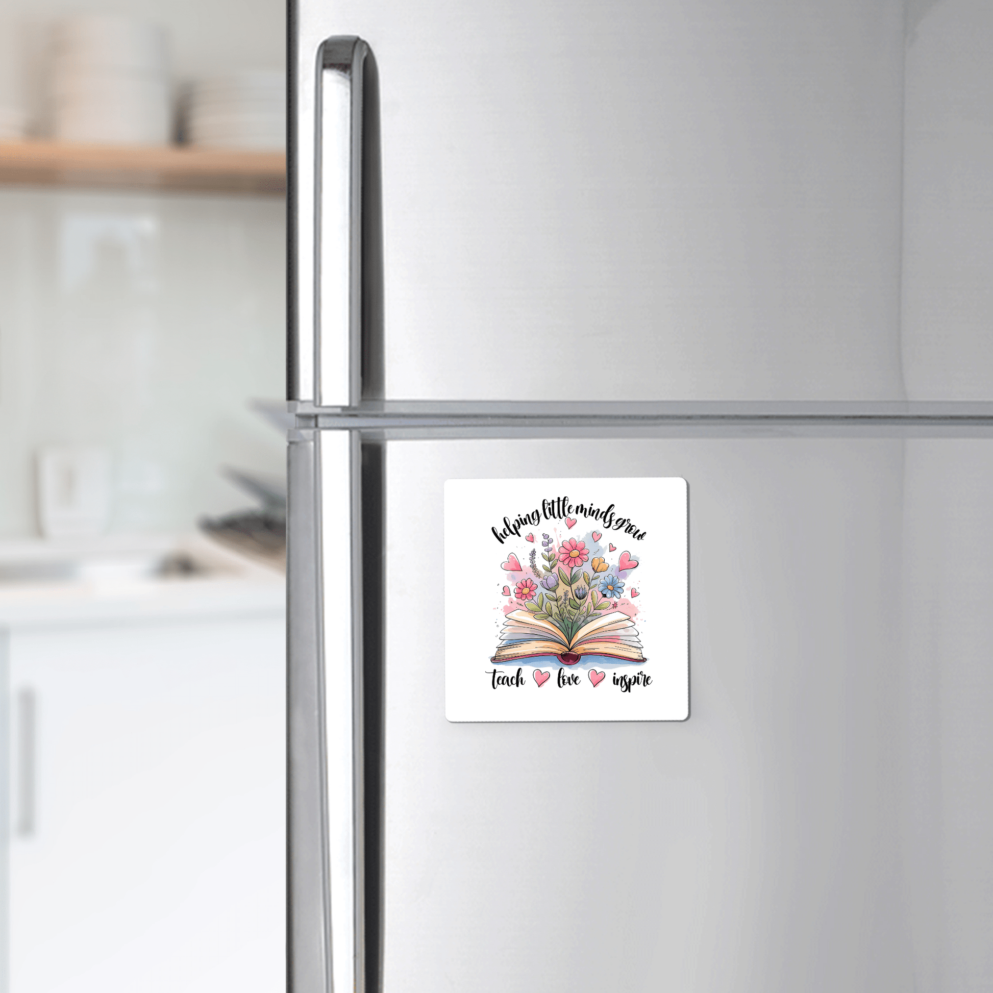 The Helping Little Minds Grow Magnet by Mirabilia Boutique features floral book art and inspiring text, making it an ideal teacher gift or classroom decor for showing appreciation.