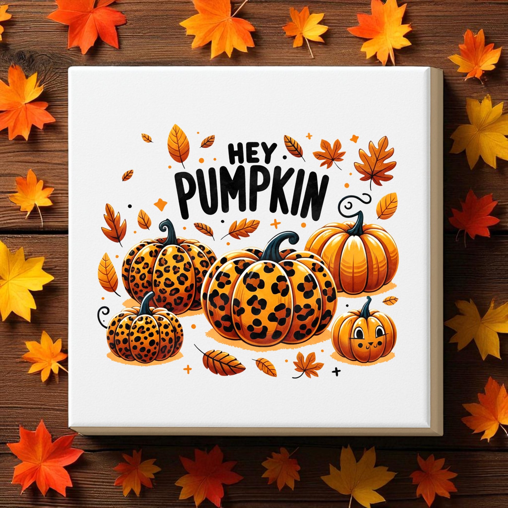 The Hey Pumpkin Canvas Sign | 8x8 Fall Leopard Pumpkin Art by Mirabilia Boutique features chic leopard print pumpkins and autumn leaves, adding seasonal charm to any space. Perfect fall decor for your home or office.