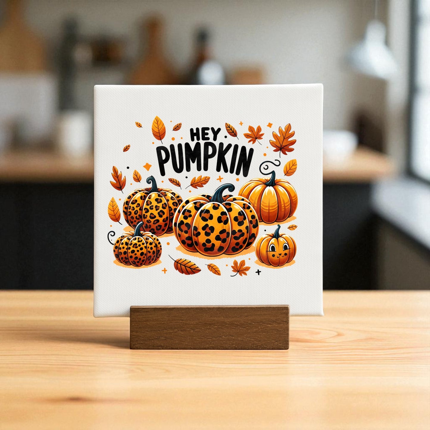 The Hey Pumpkin Mini Sign by Mirabilia Boutique features leopard print pumpkins and autumn leaves on canvas, with "HEY PUMPKIN" text—perfect fall decor for your kitchen.