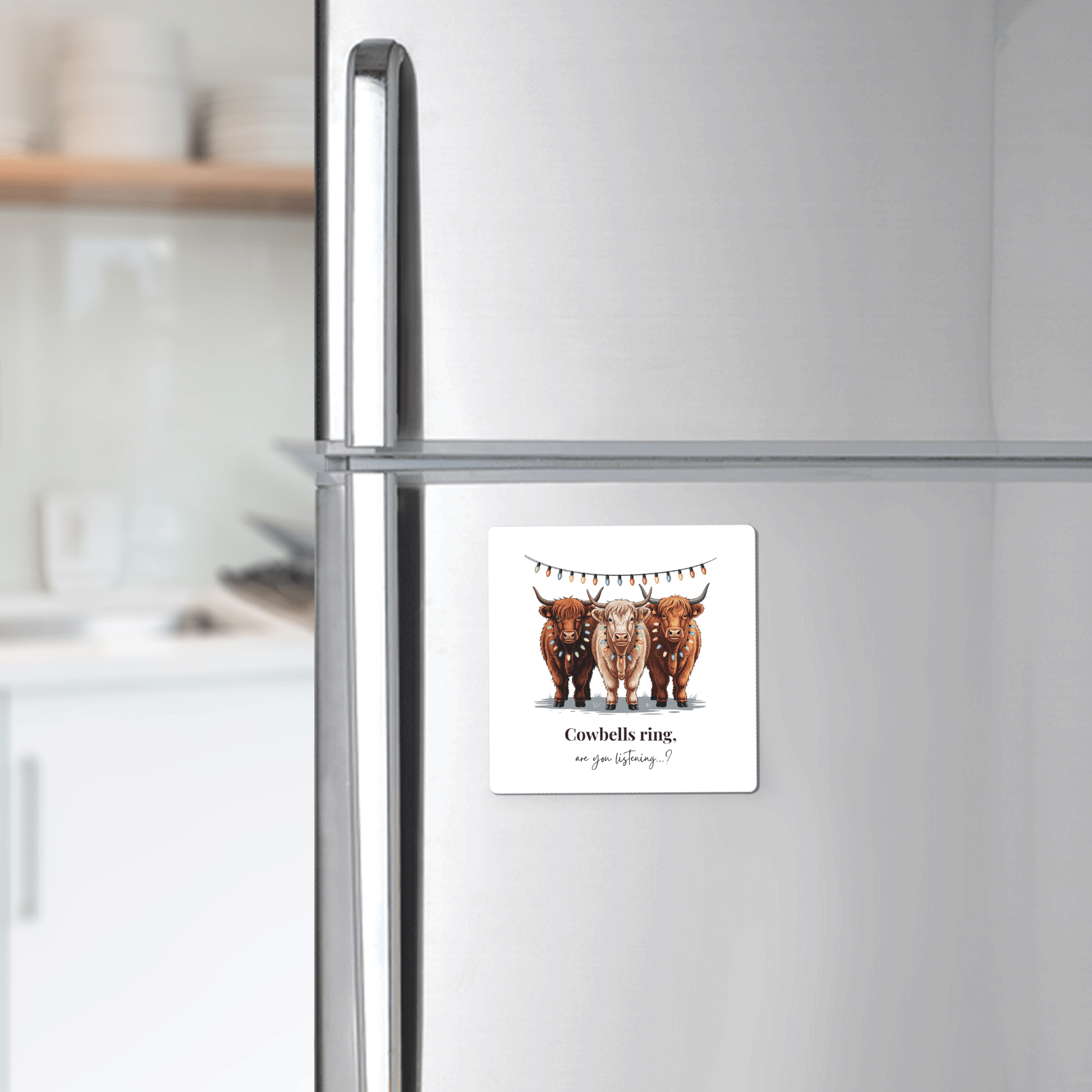 A Mirabilia Boutique Highland Cow Christmas Magnet, "Cowbells Ring," shows three festive cows under bunting on a fridge—perfect farmhouse holiday decor or a cute gift for cow lovers.
